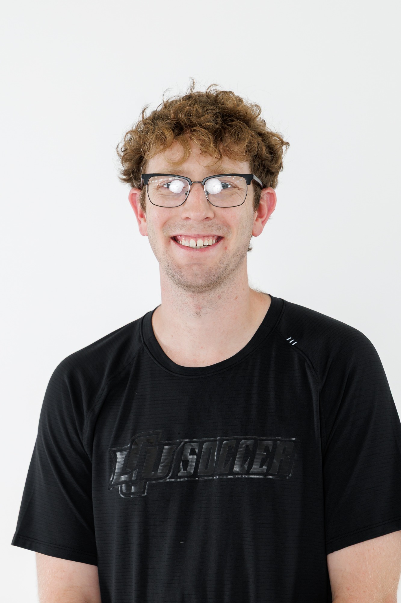 Head shot of an LCU men's soccer player in a black polo