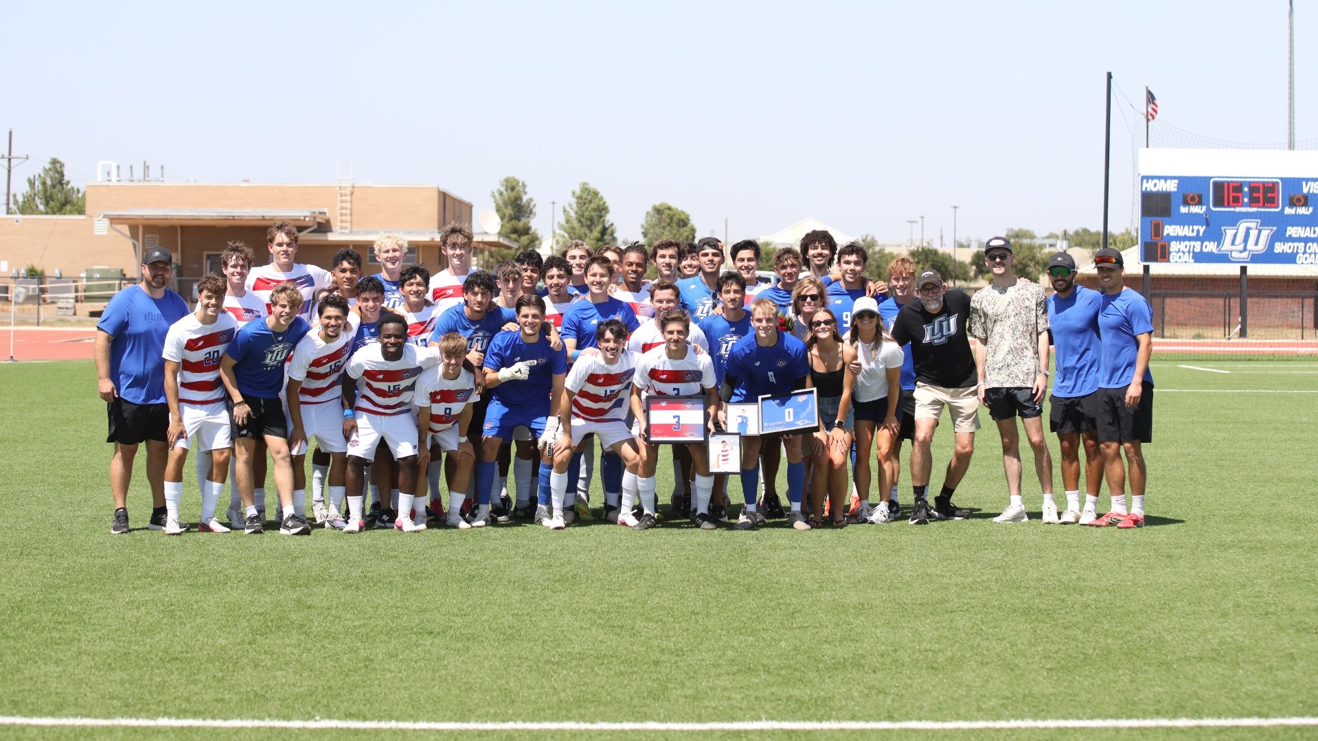 The Lubbock Christian men's soccer teams surrounds its two seniors and their families at the LCU Soccer & Track Complex. 
