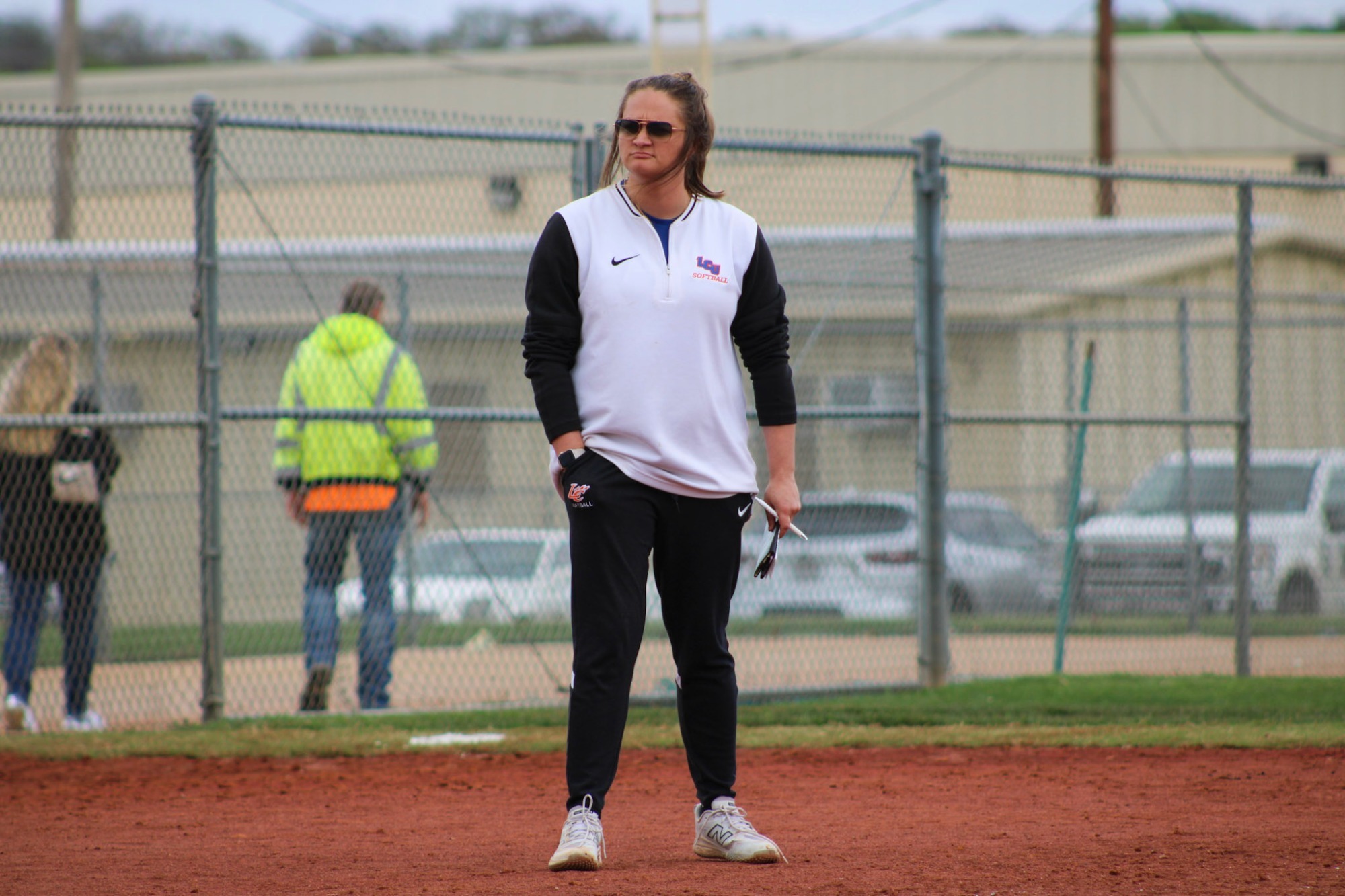 Mattie Stine standing in 3rd base coaching box