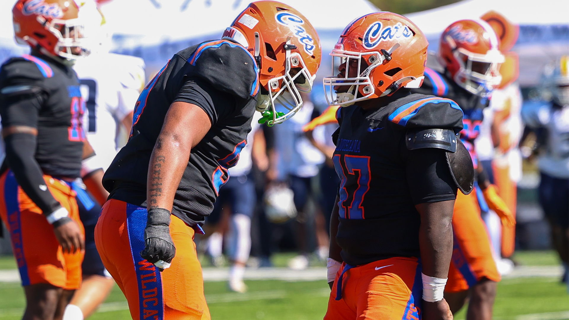 Two Wildcat defenders celebrate play vs. Texas Wesleyan 10/10/26