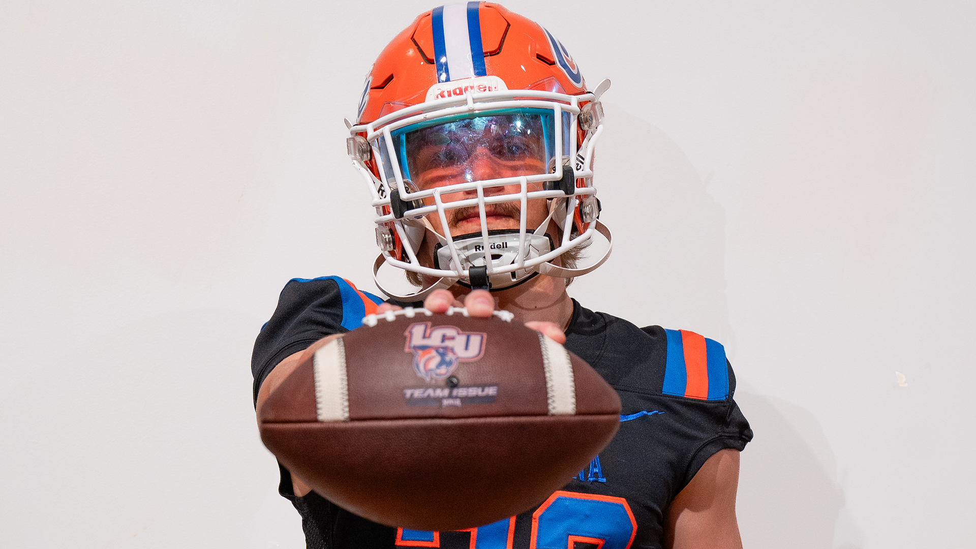 Travis Adams Holding Football to Camera