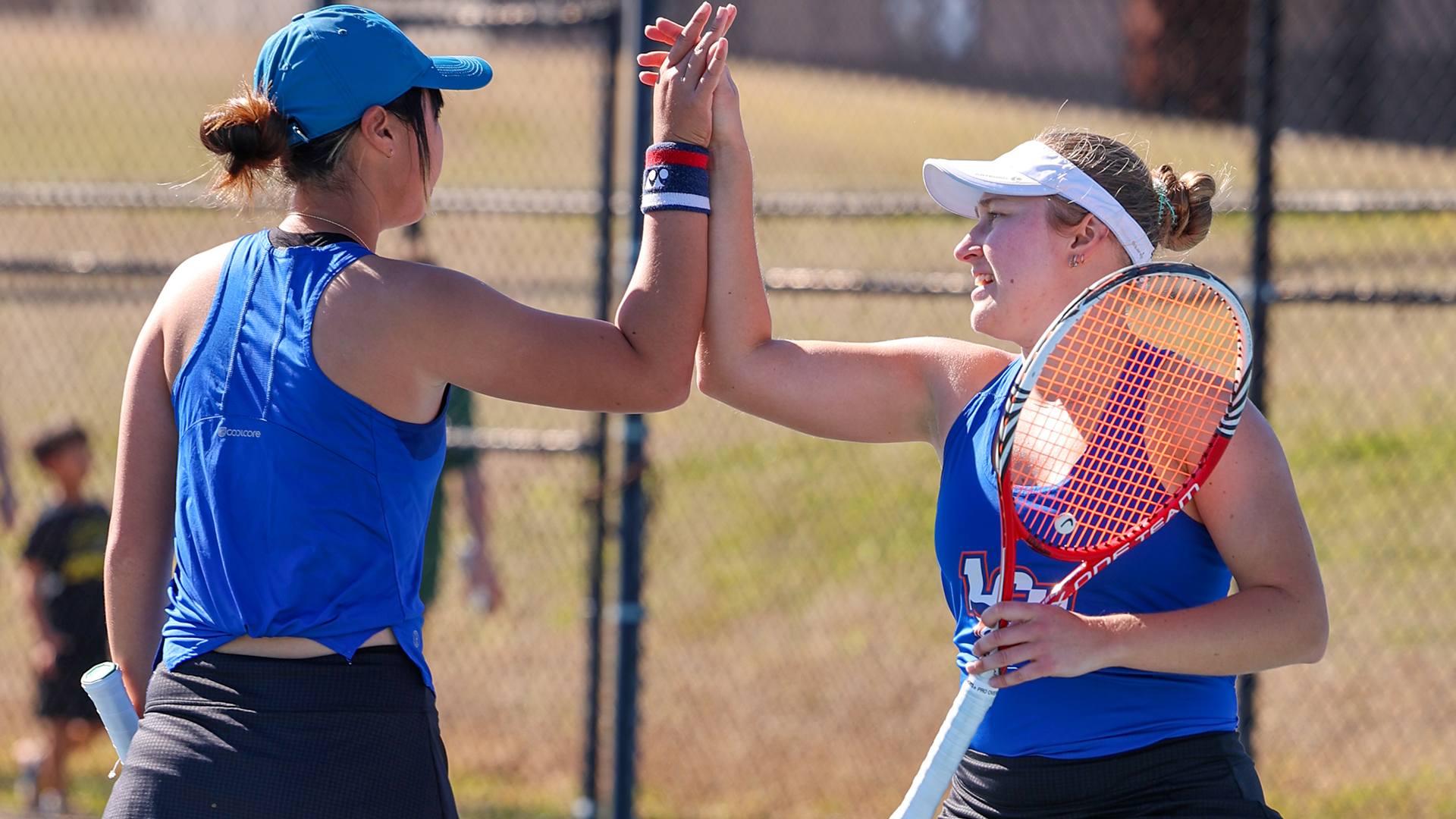 Akari Uchiyama and Ana Sofia Ferrer Martinez high-5 during match vs. SLU 2/7/26
