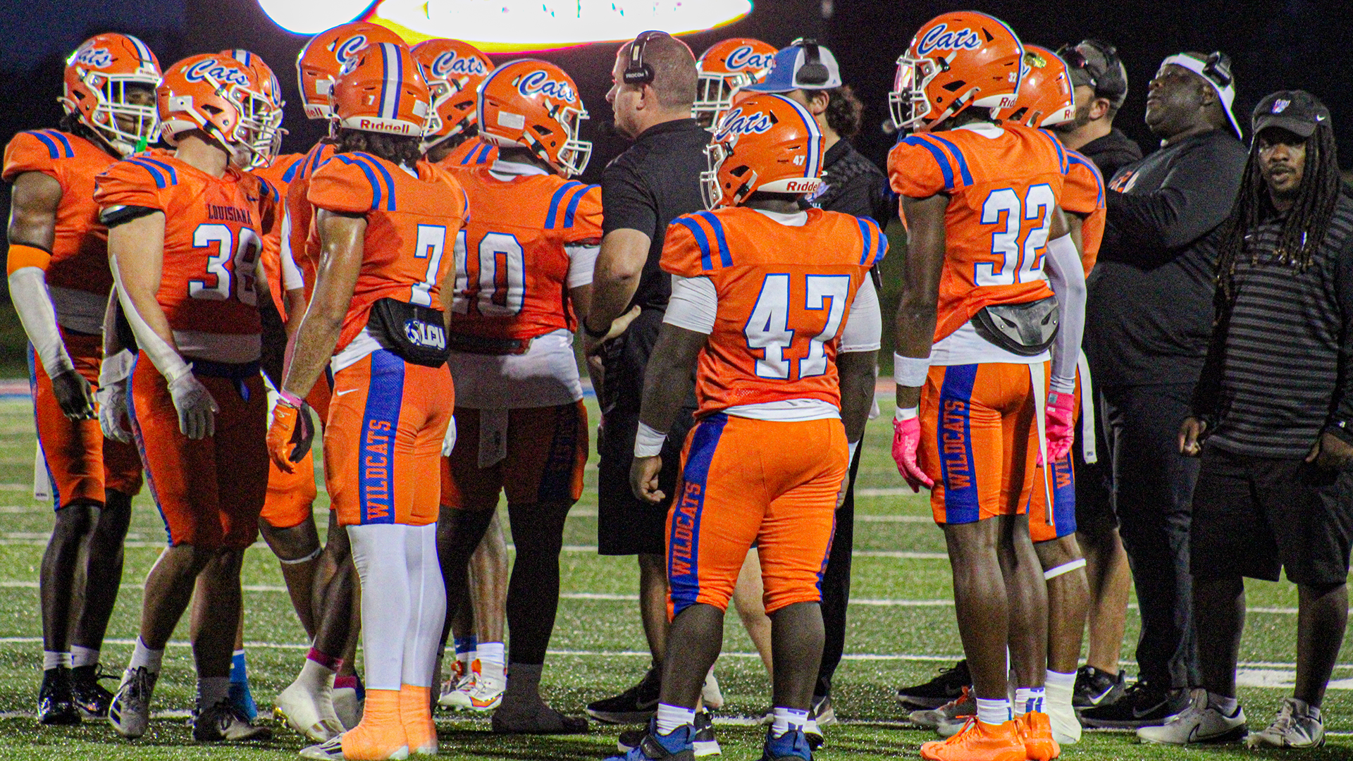 Wildcat football team huddled around coach during timeout vs. Texas College 10/24/25
