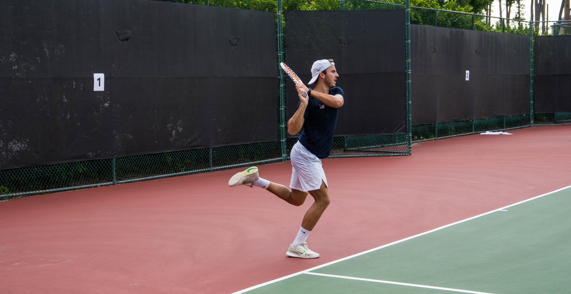 Quinn returning serve against SLU