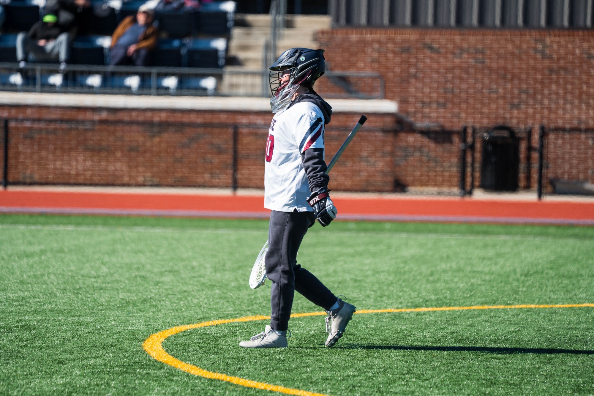 Lacrosse goalkeeper Savannah Wiseman looking at the play on the other side of the field