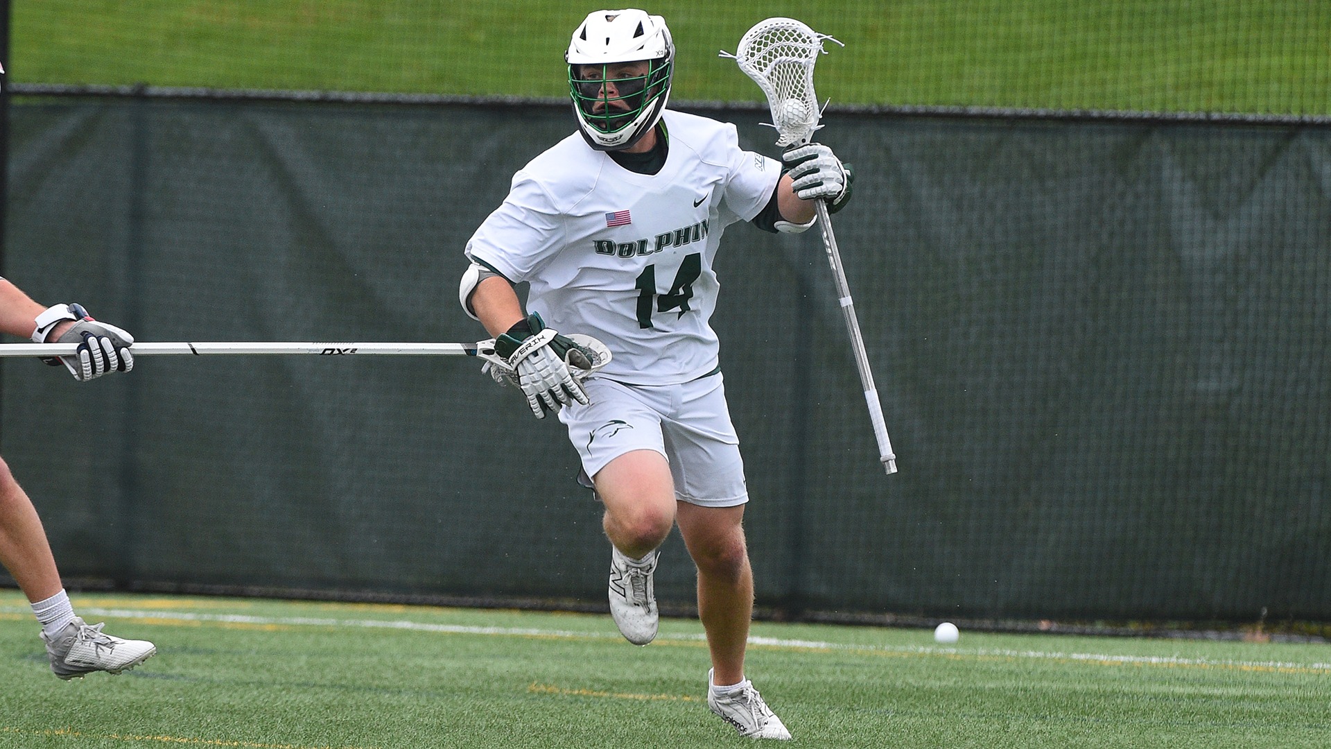 Thomas Berry carries the ball behind the net against Robert Morris