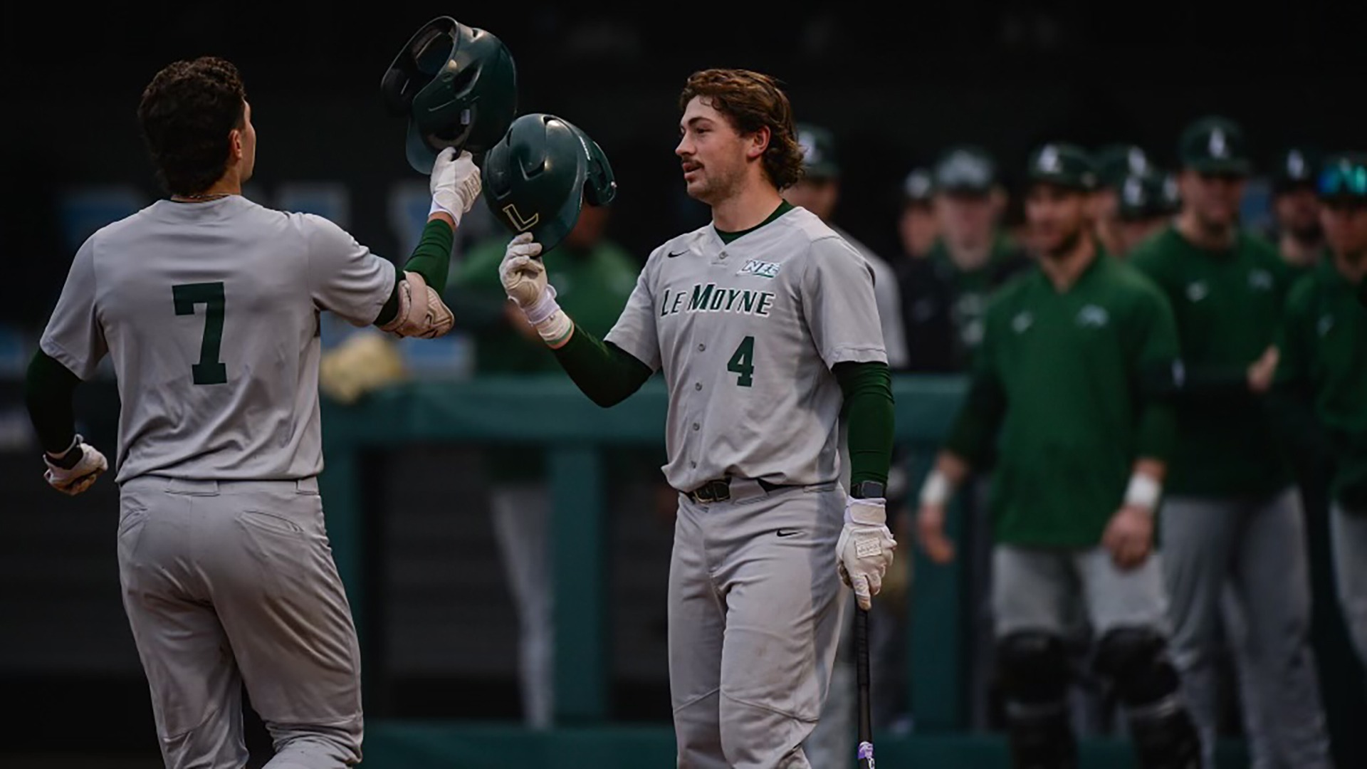 Adam Sullivan and Cooper Romich tap helmets after Sullivan home run