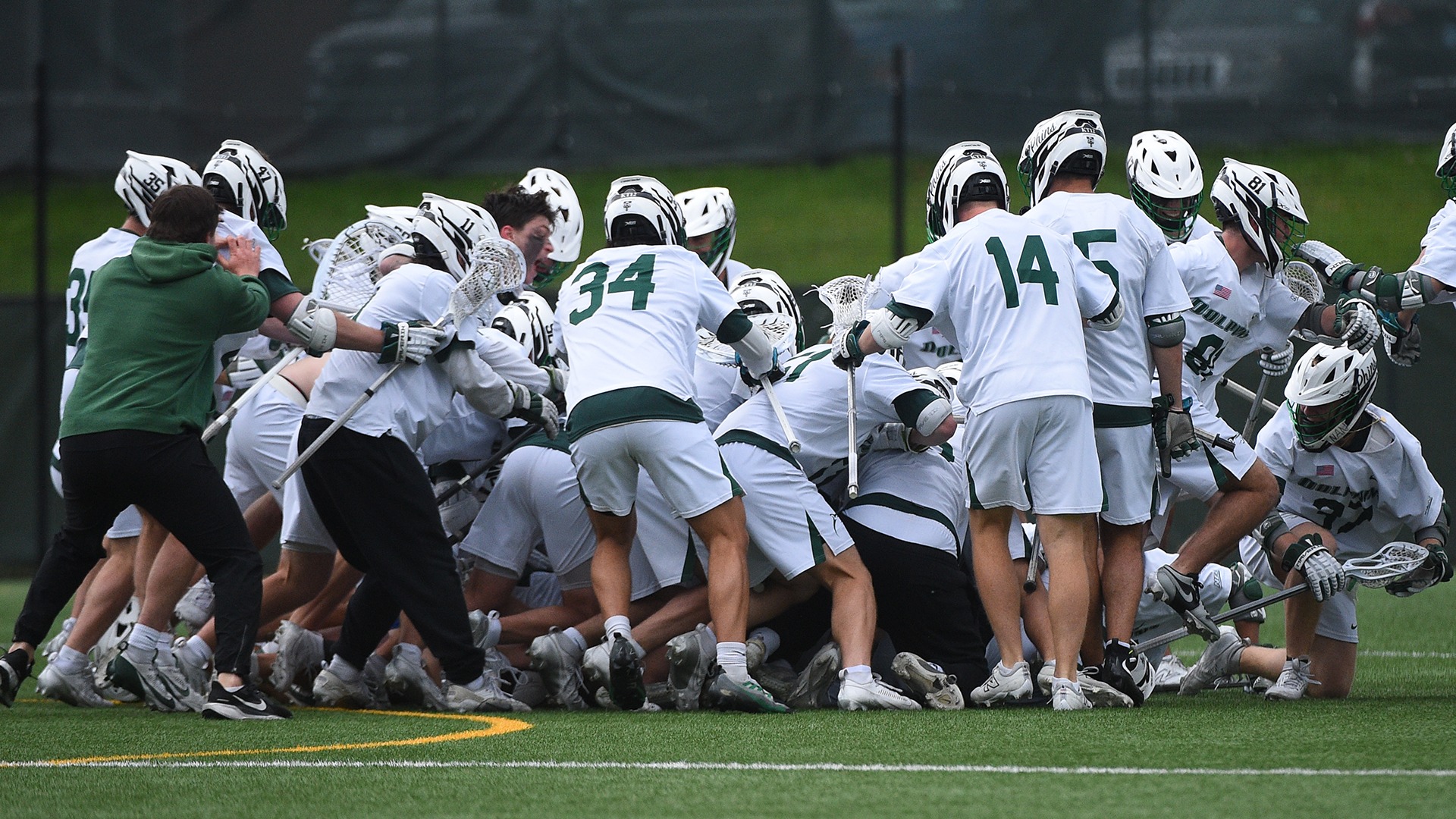 Men's Lacrosse dogpile following overtime win over Robert Morris