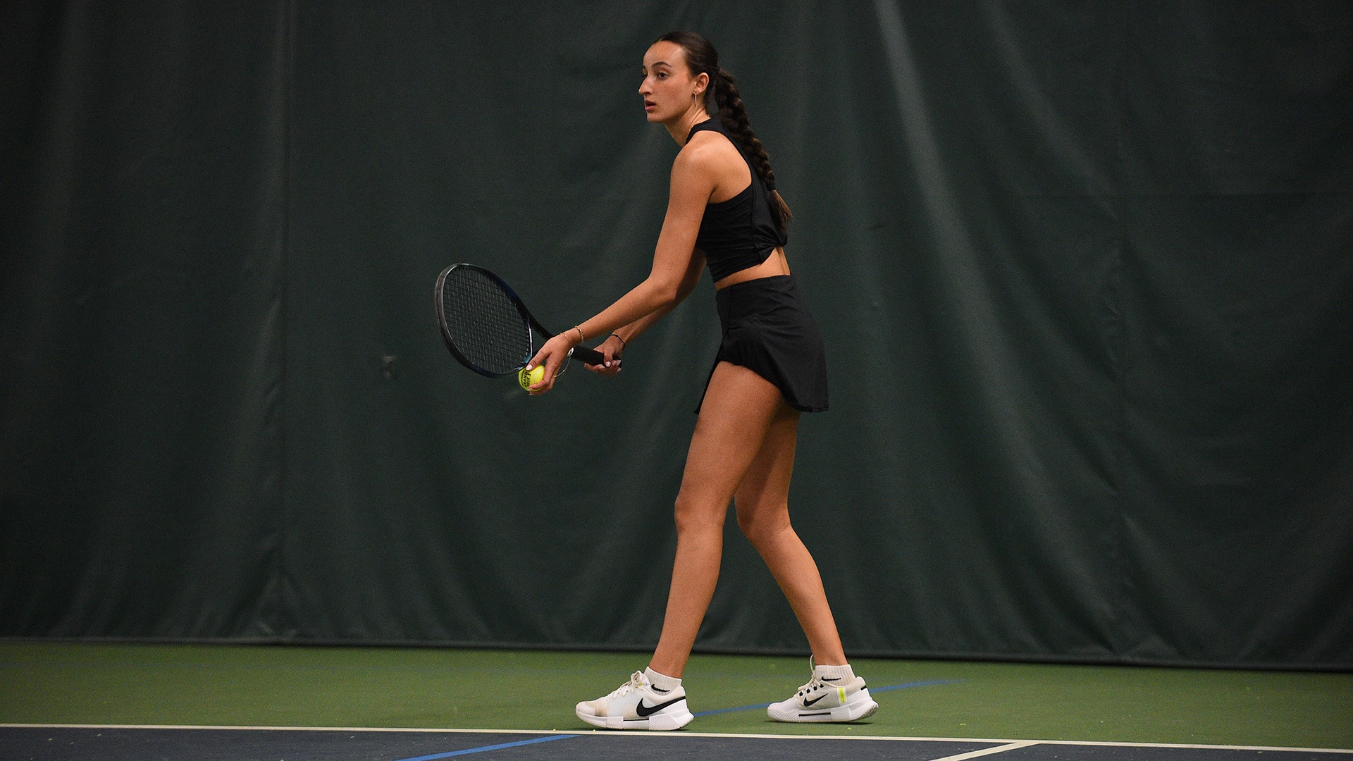 Lilia Raiss prepares to serve against Binghamton