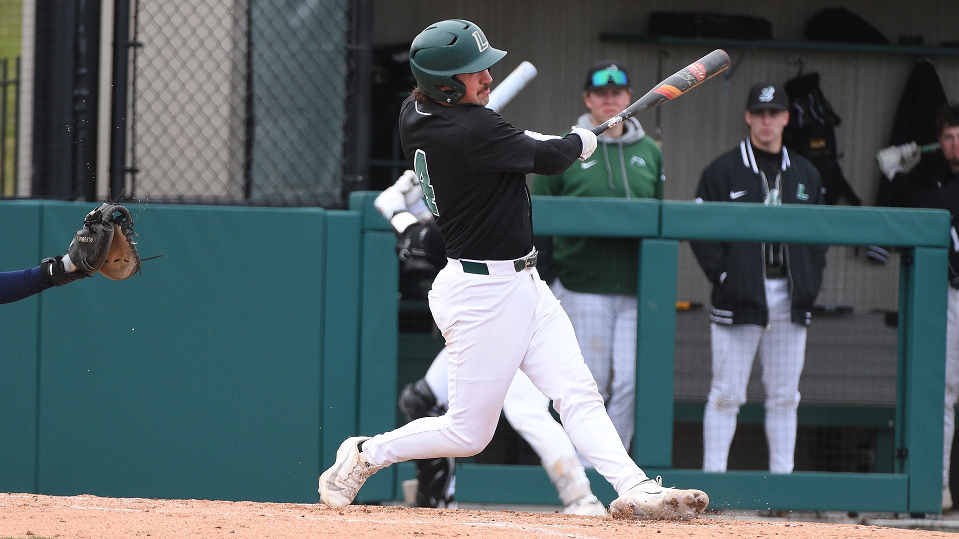 Cooper Romich follows through on a swing against Coppin State