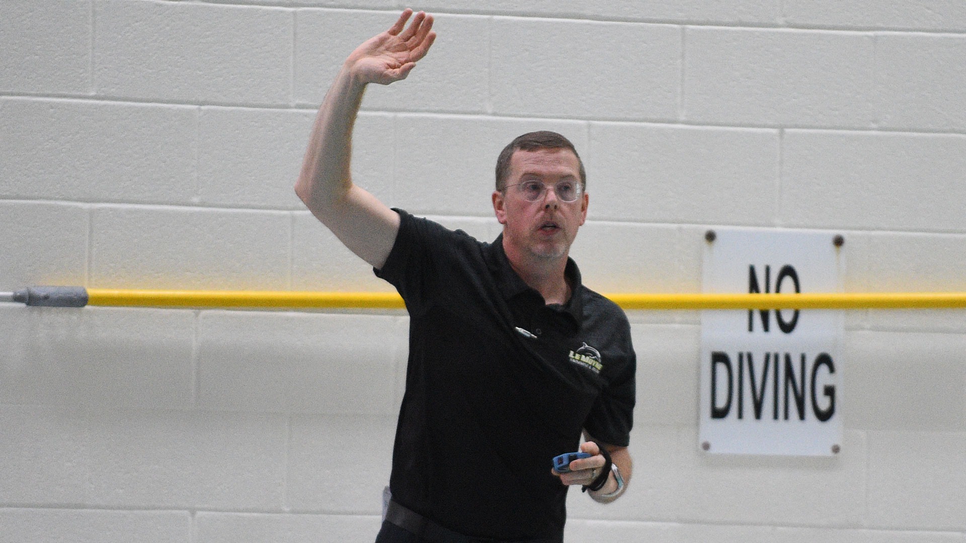 Adam Zaczkowski encourages a swimmer during a home meet against St. Bonaventure