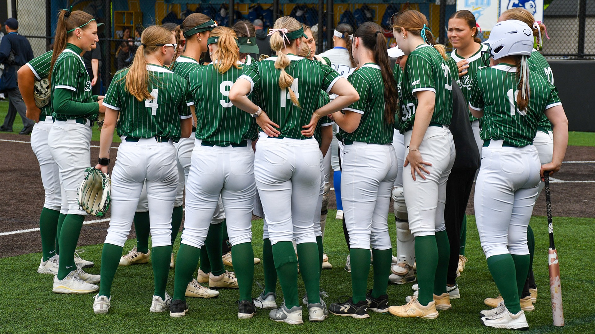The softball team huddles prior to an NEC Tournament game