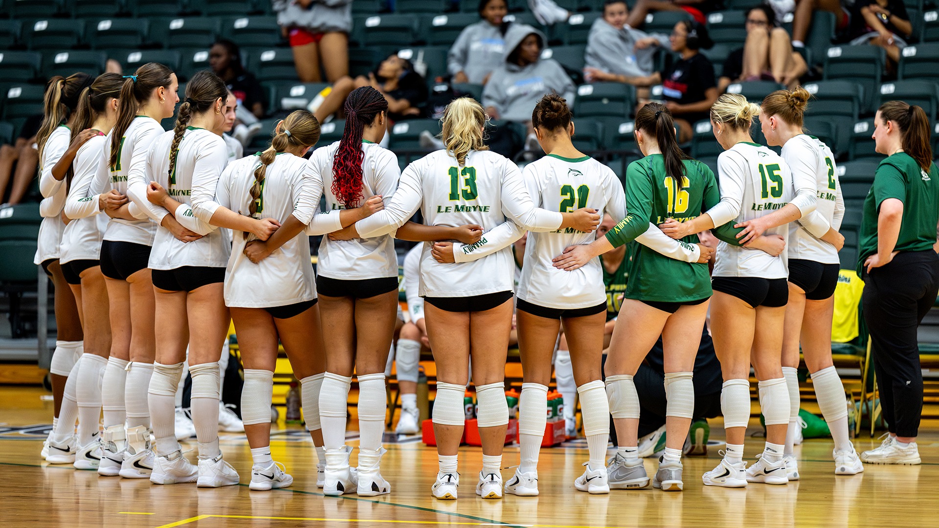 Volleyball team huddles during a timeout against Bucknell