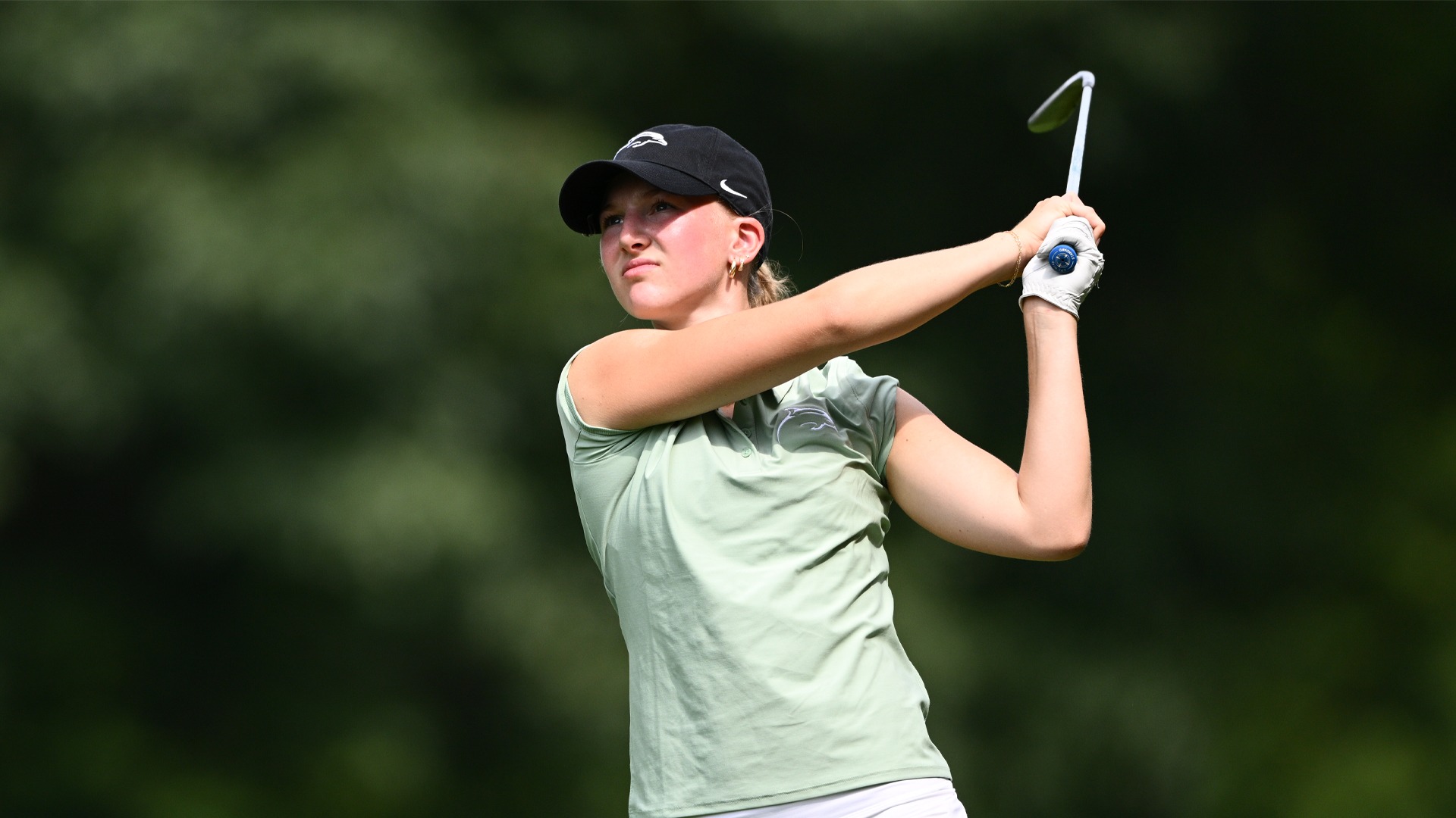 Kamryn Yerman follows through on an iron shot at Roseann Schwartz Invitational