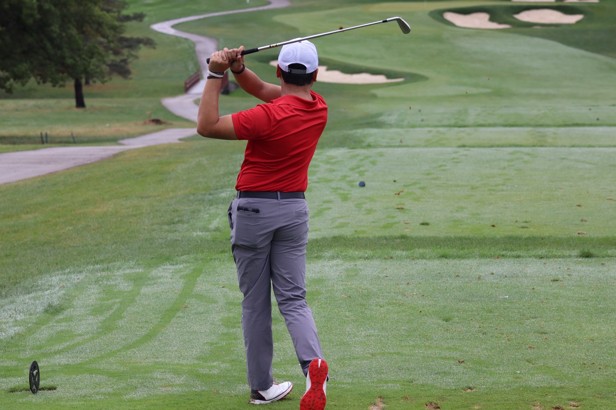 Atendido hits a tee shot.