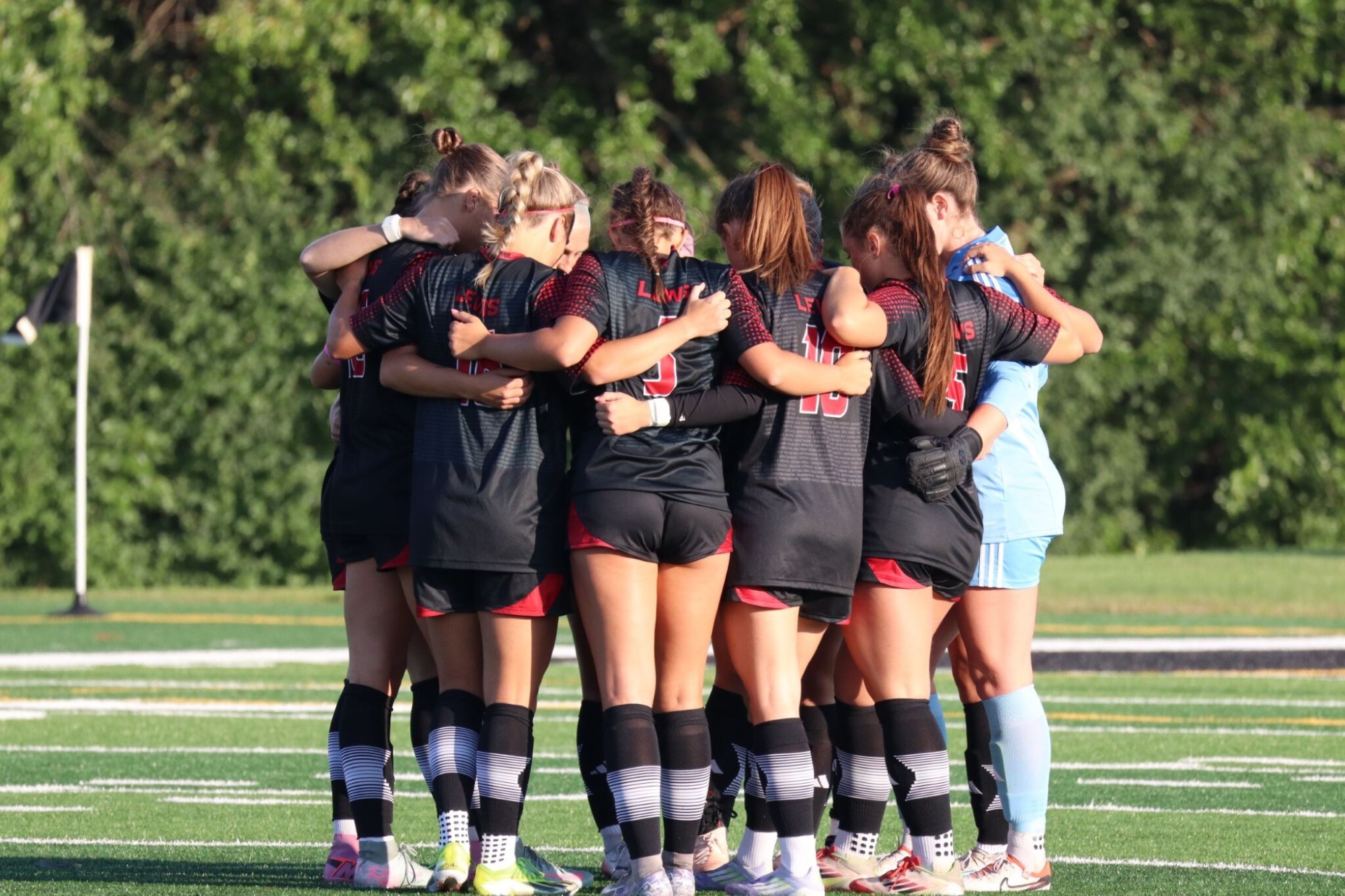Flyers Huddle During Roosevelt Game