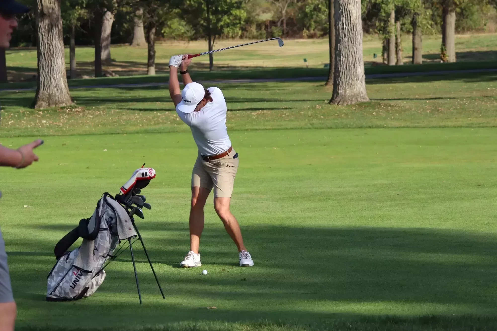 Ethan Hermann hits approach shot for the green.
