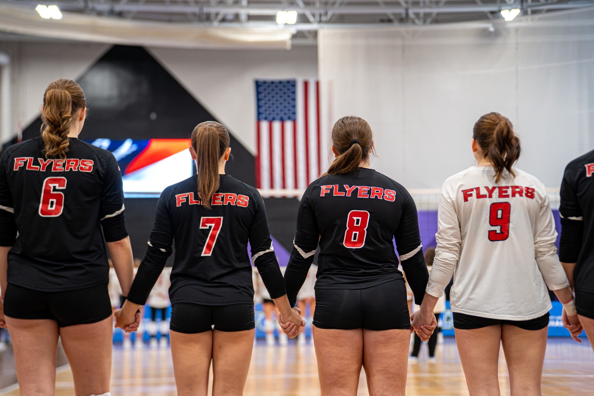 Volleyball players look at the flag
