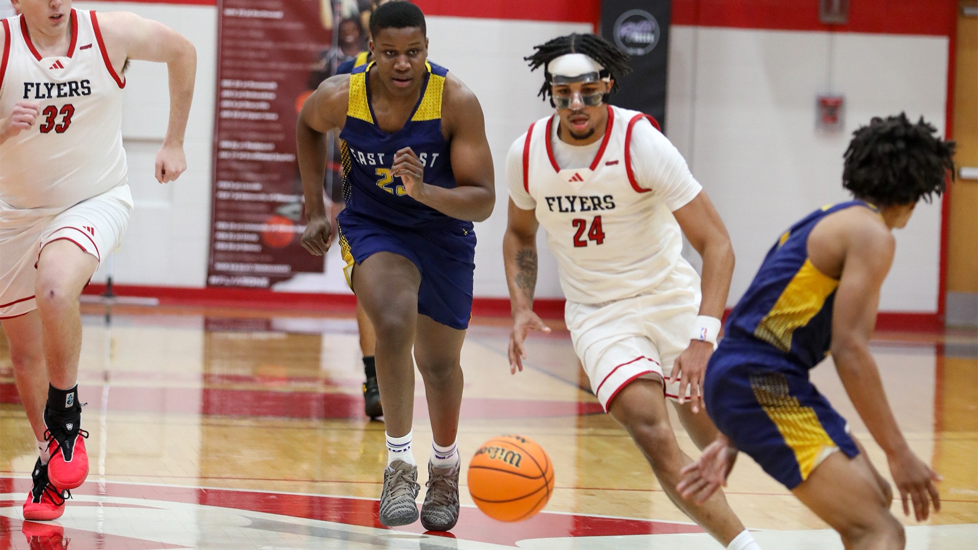 Drew Fisher dribbles up the court against East West