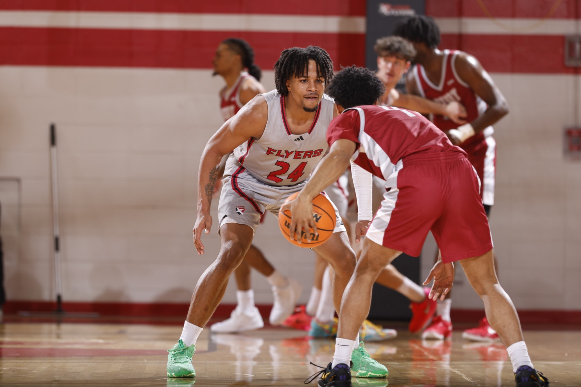 Drew Fisher guards a UIndy player