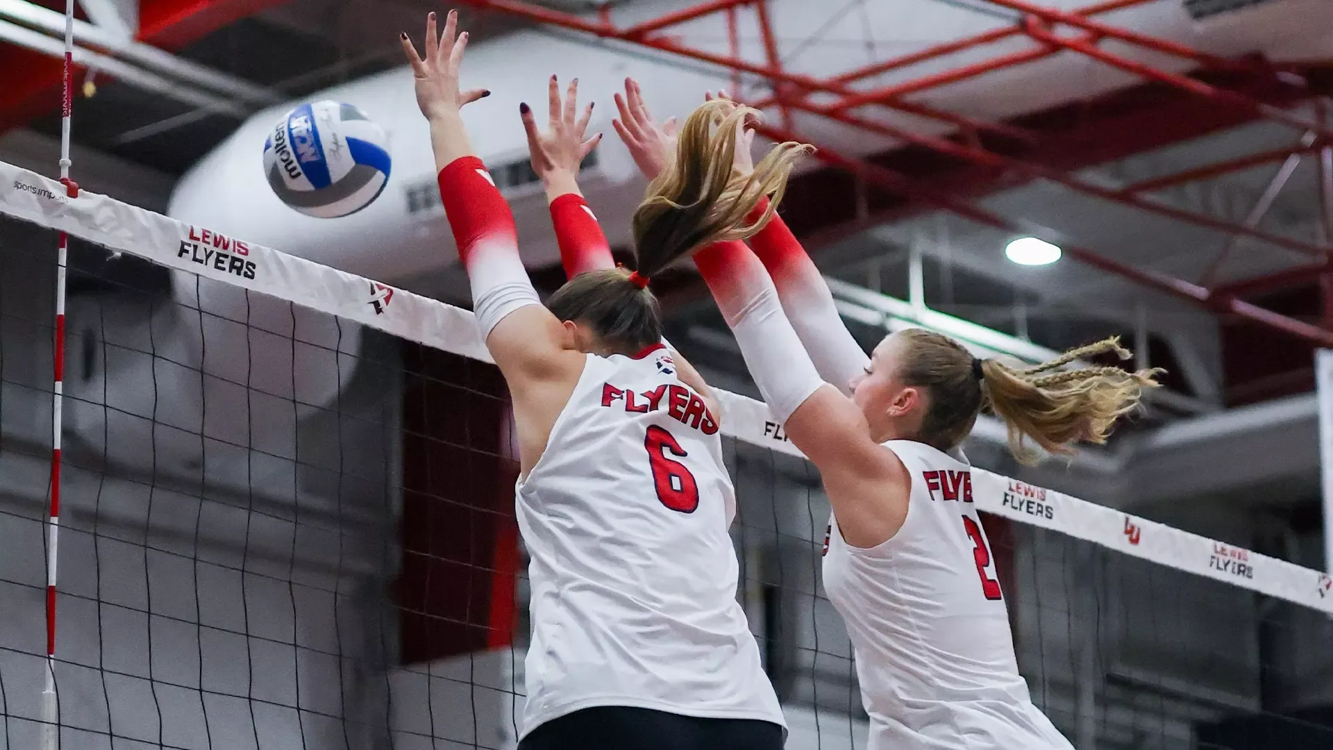 Lauren Buxton and Hannah Dietzenbach go for a block