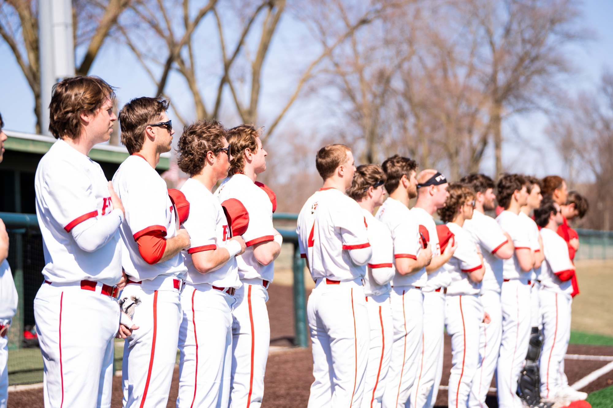 Lewis players stand for the national anthem