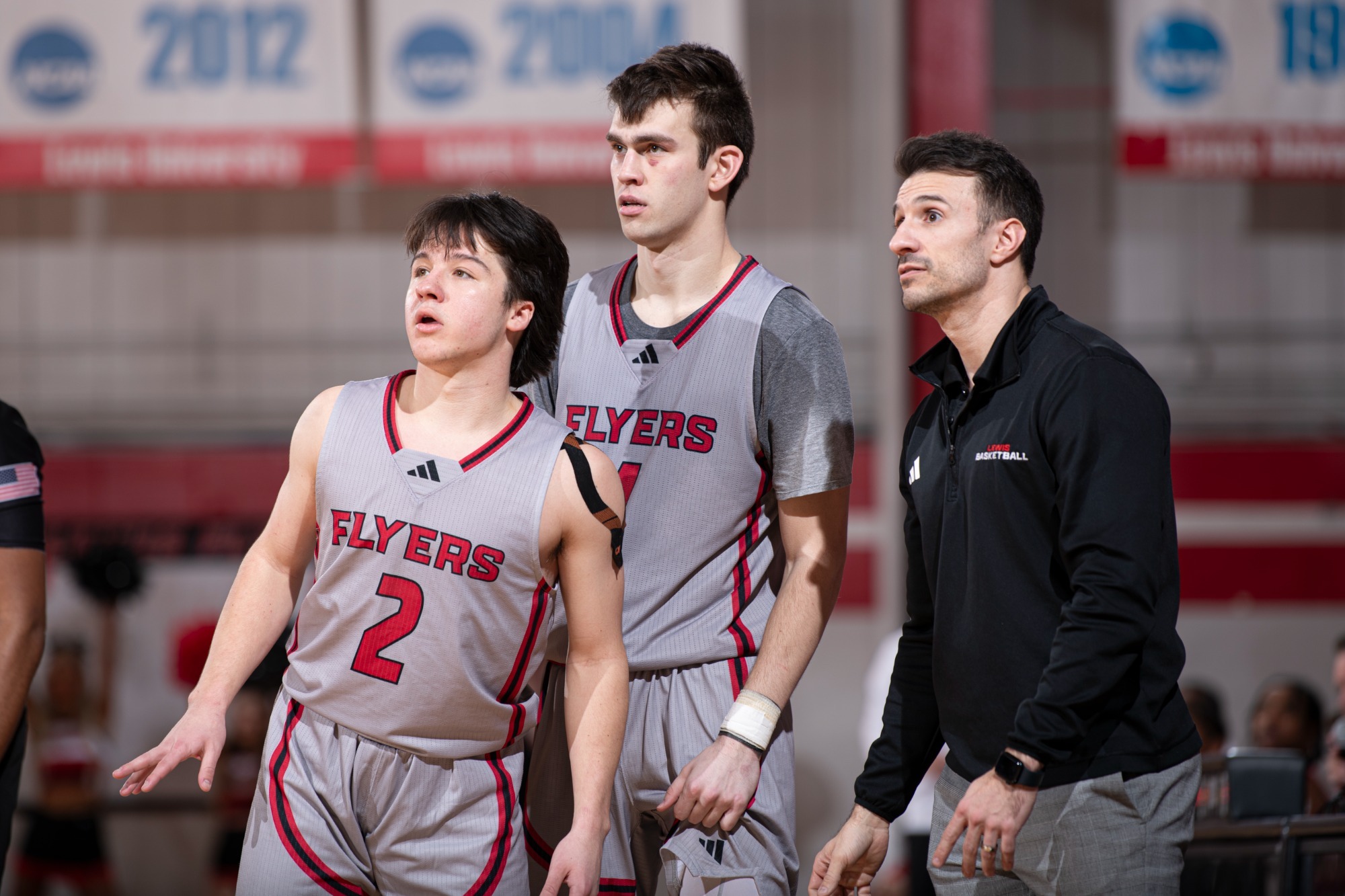 Cale Cosme, Ryan Hall and Nick Rocco look at the scoreboard
