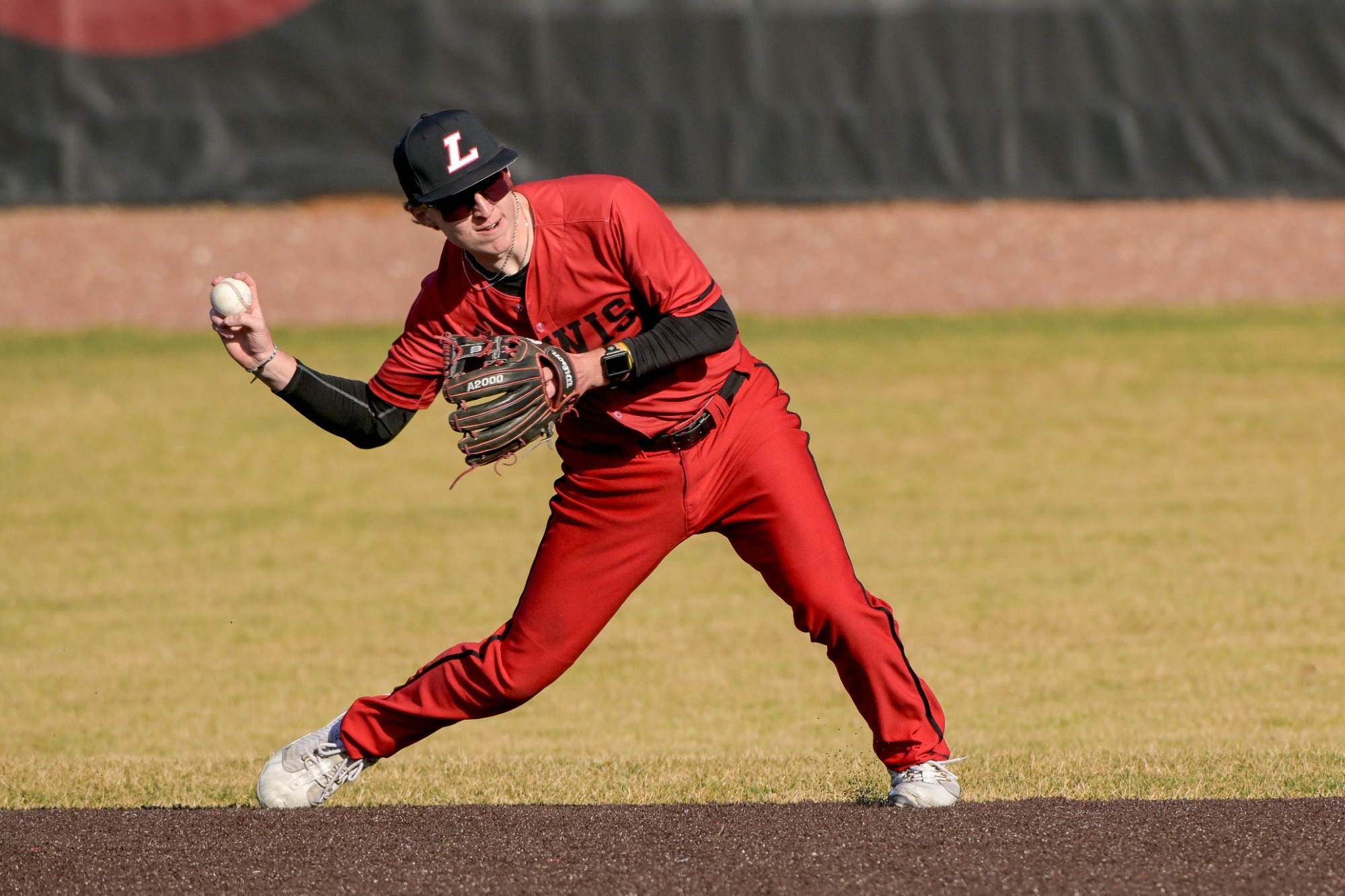 Tylor Phommachanhom throws a ball to first base