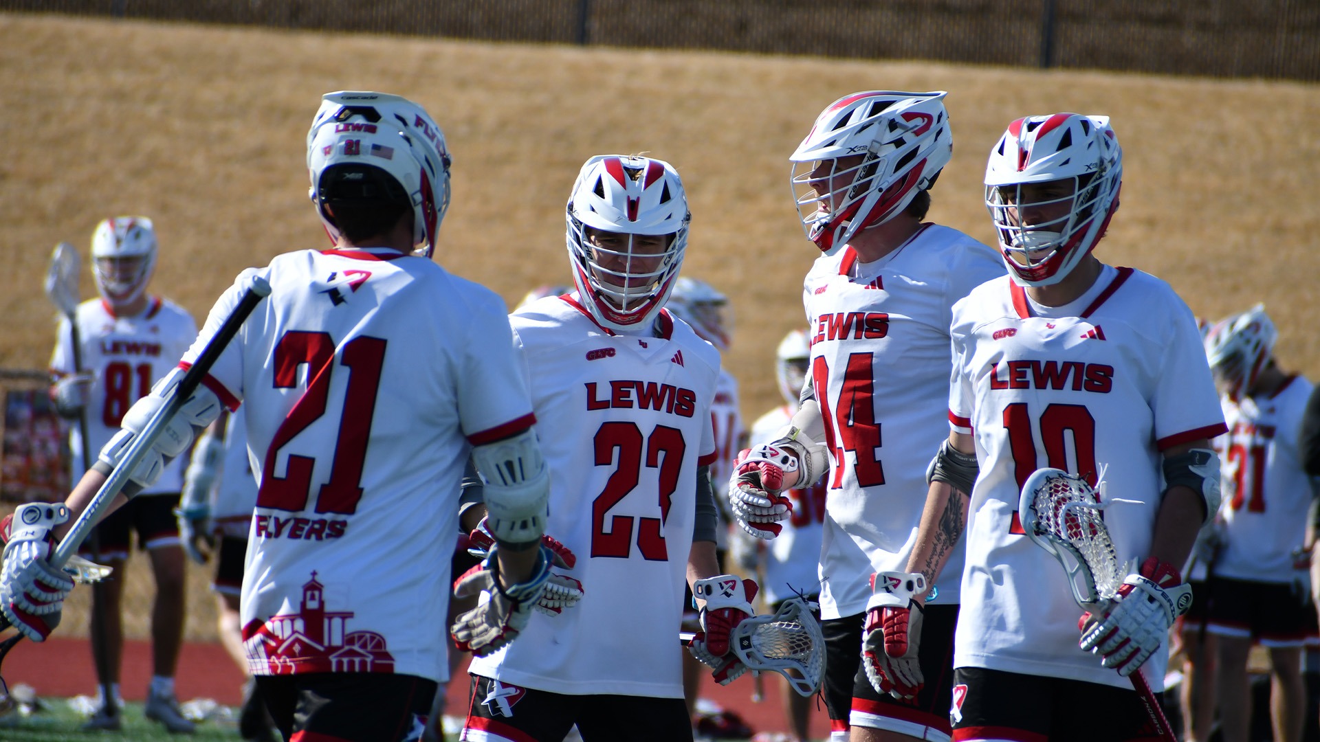 Men's lacrosse huddle after a goal
