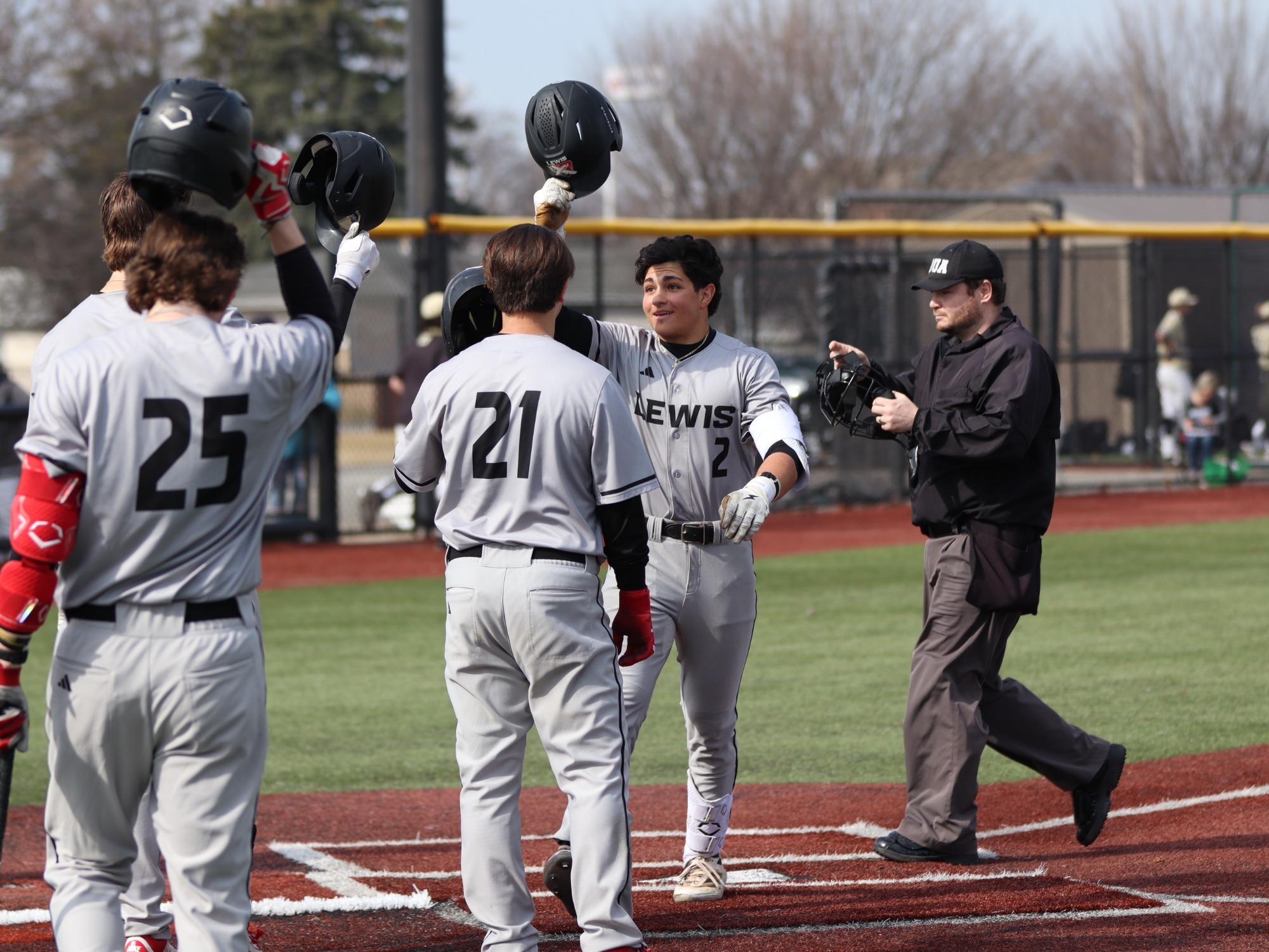 Constantine Coins celebrates with his teammates at home plate