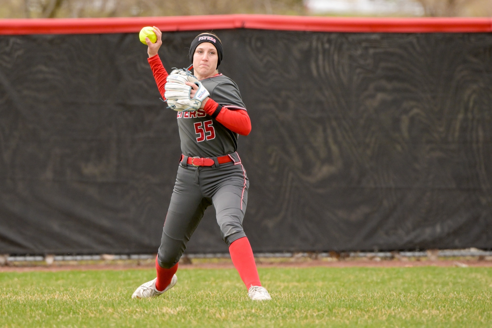Chloe Kohnhorst throws a ball back to home plate