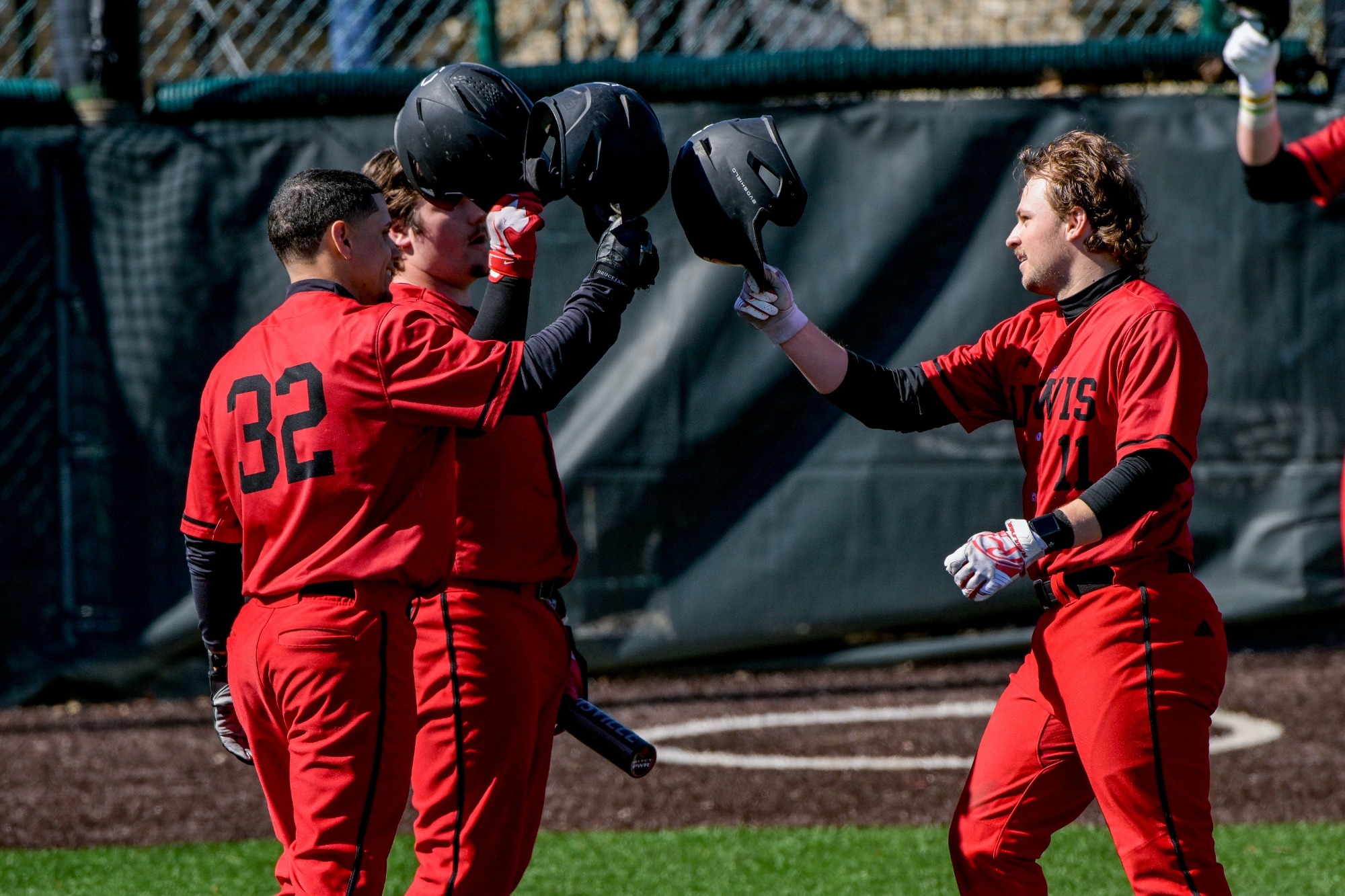 Lewis baseball players tap helmets