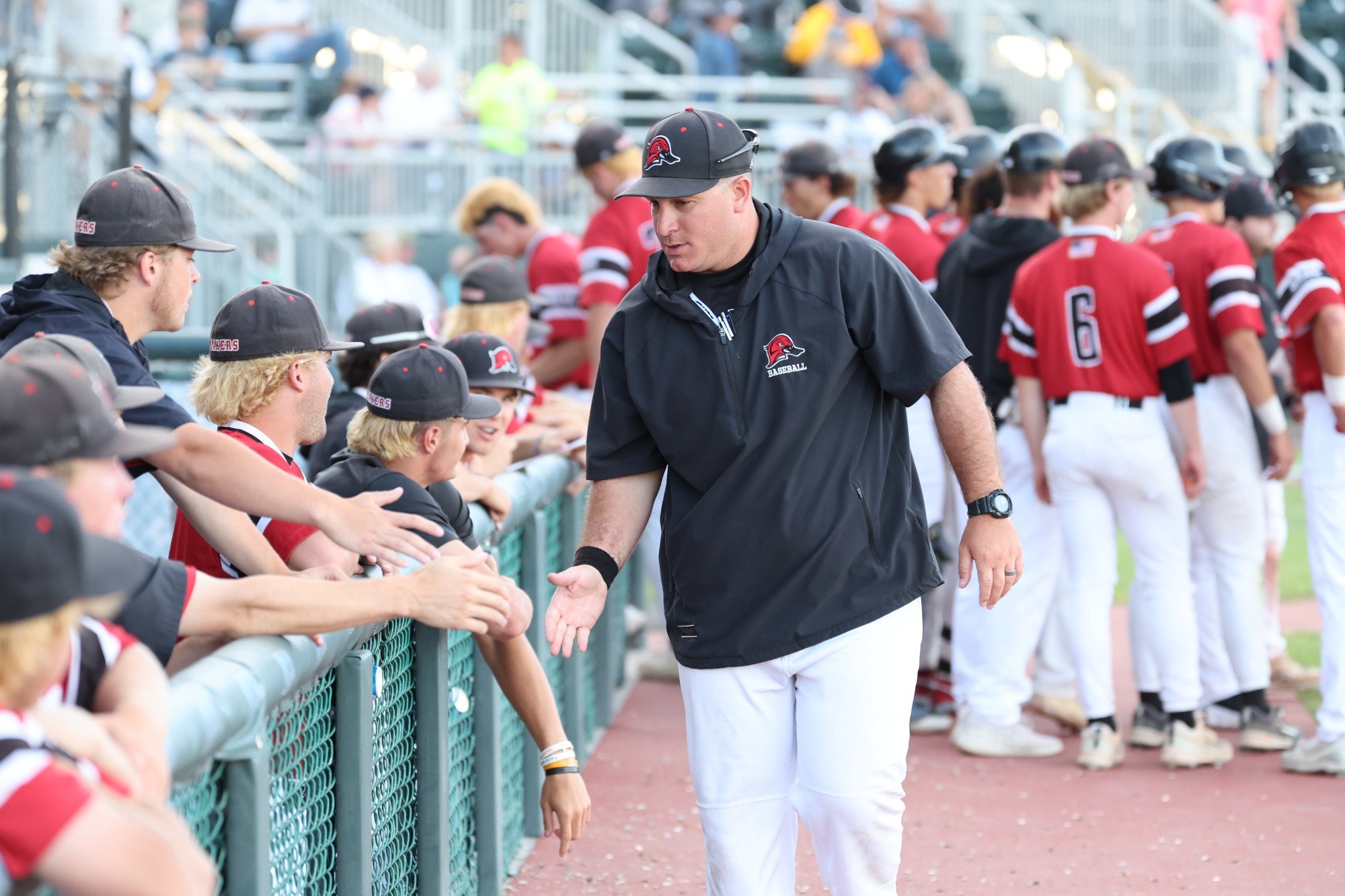 Julio Godeinez high-fives his players