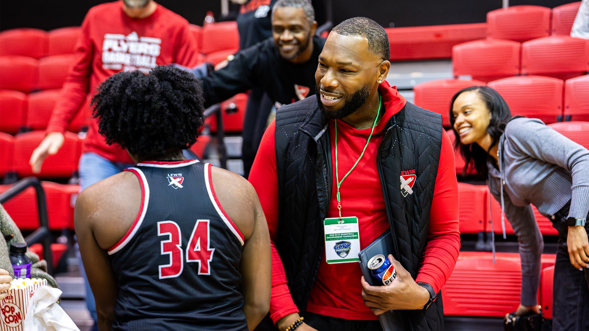 John Ashaolu celebrates with a women's basketball player