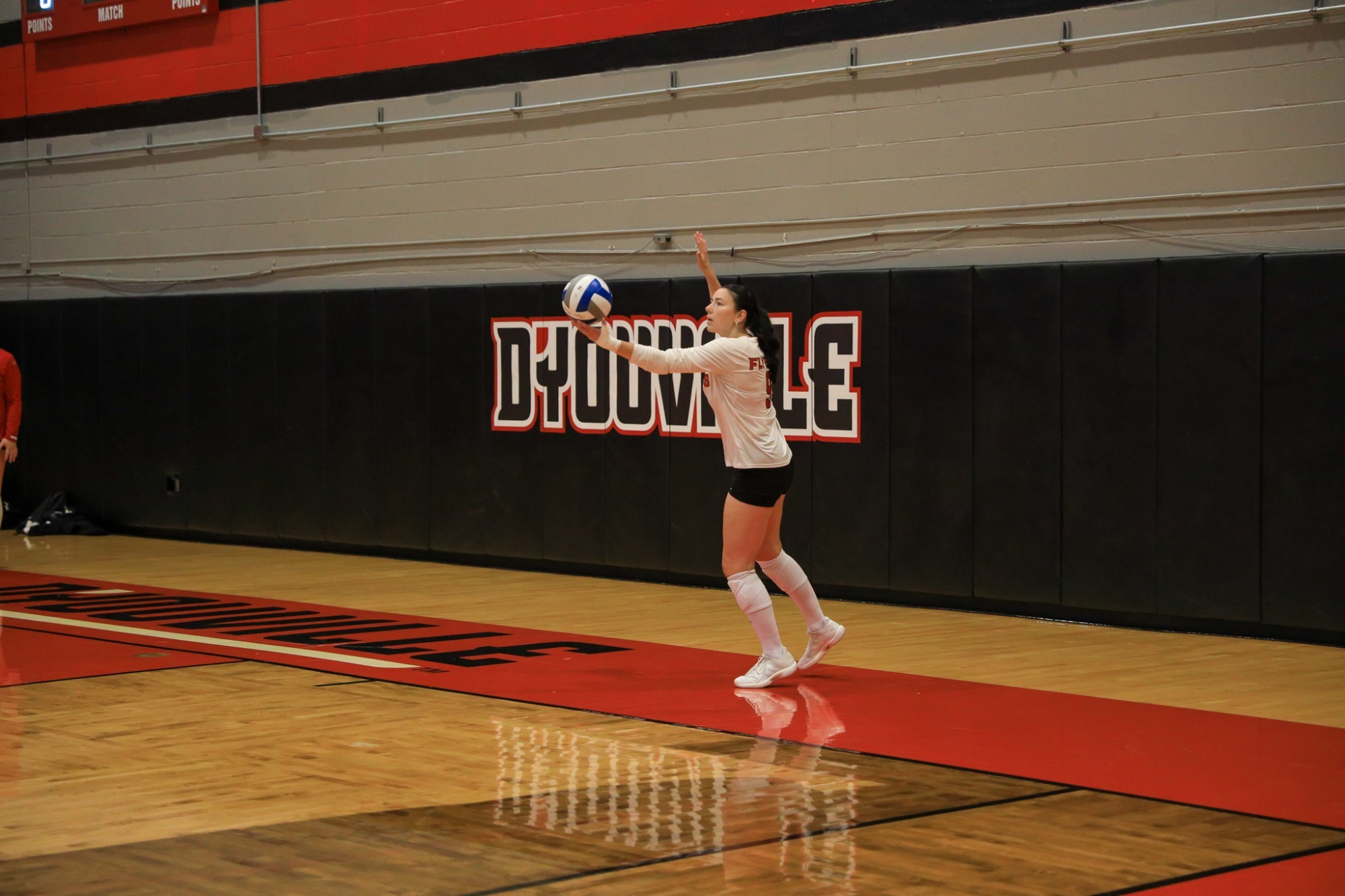 Kynzie Lilly serves at D'Youville