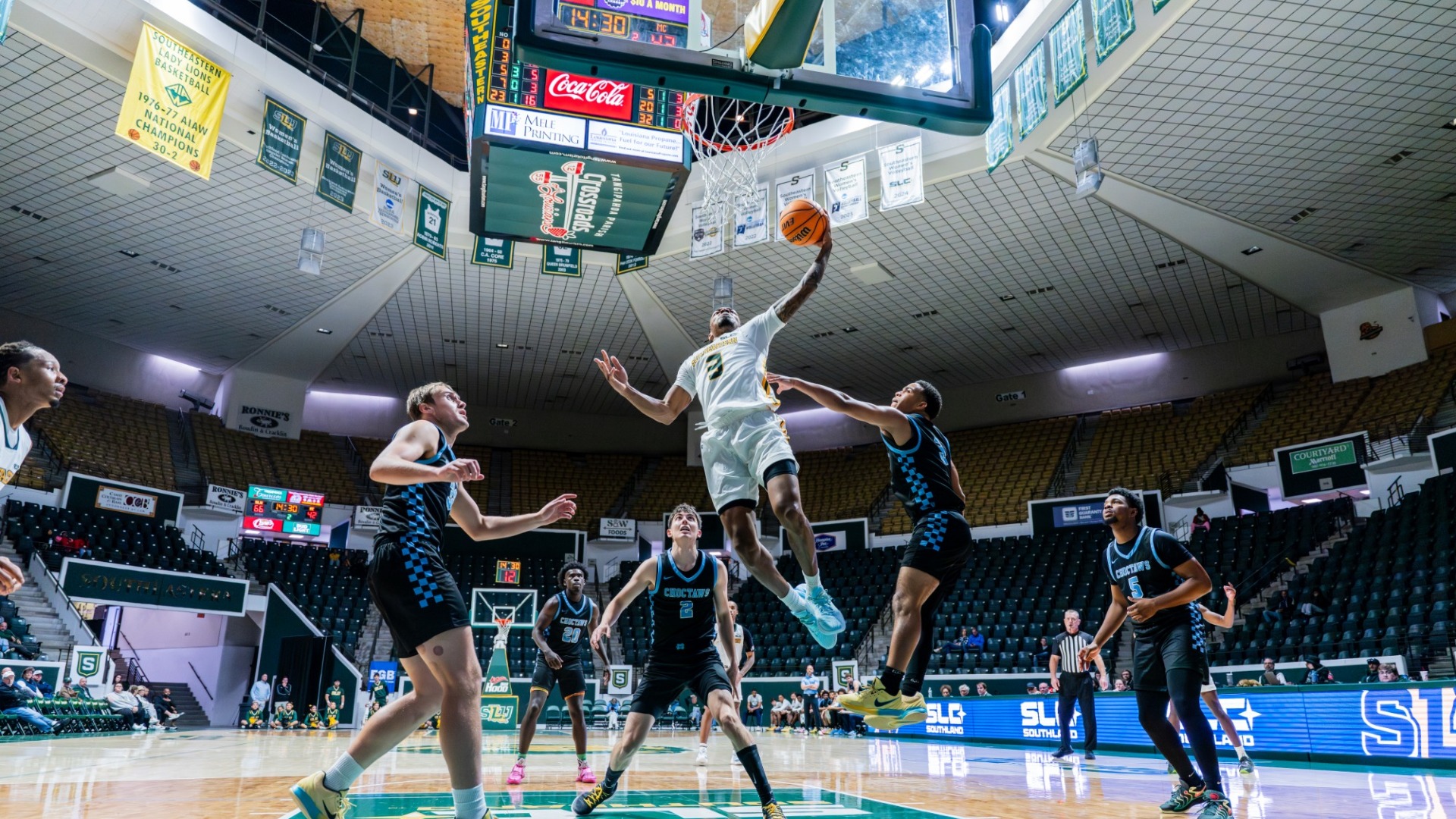 Ethan Pickett finishing around the rim against multiple defenders from William Carey