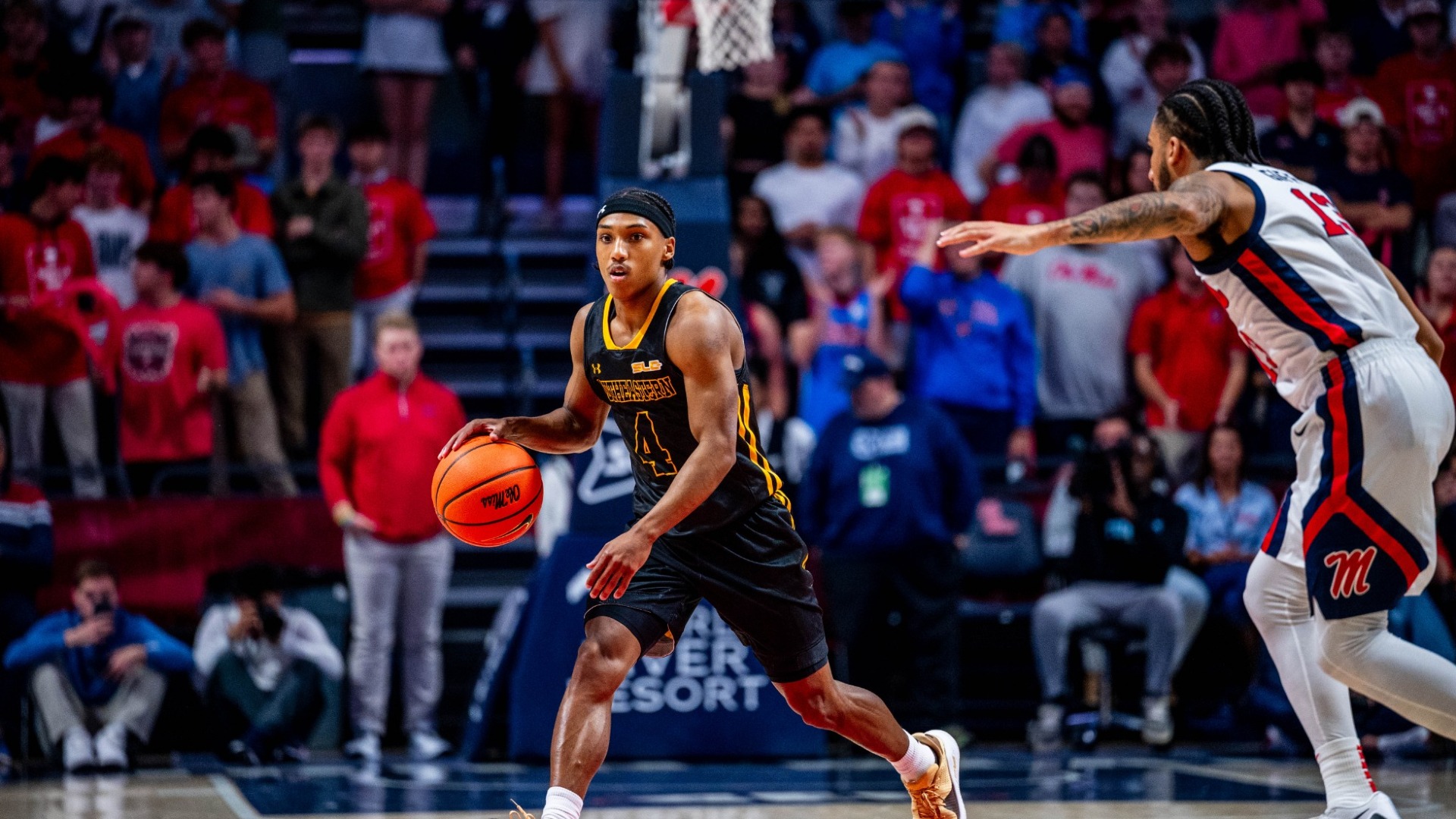 CJ Booker handling the ball vs Ole Miss defender 