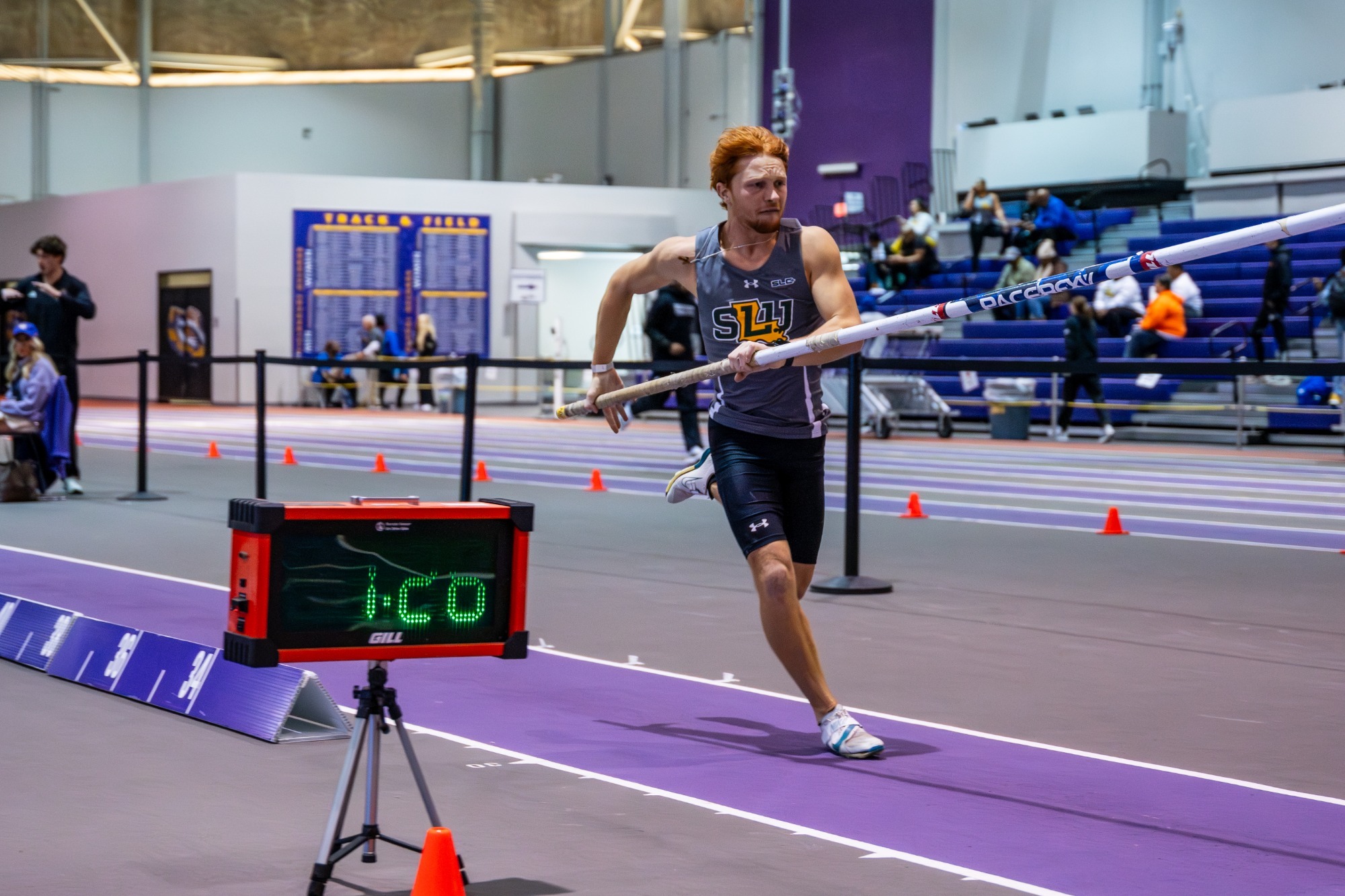Trey Faherty prepares to pole vault in the indoor season opener