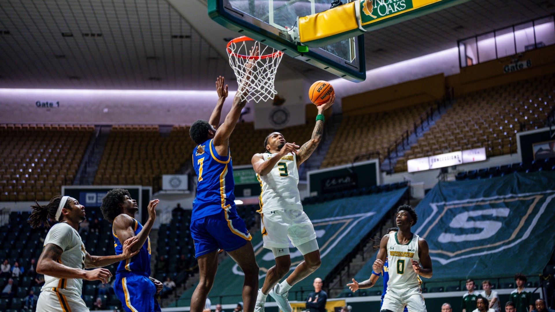 Ethan Pickett finishing around the rim vs McNeese defender
