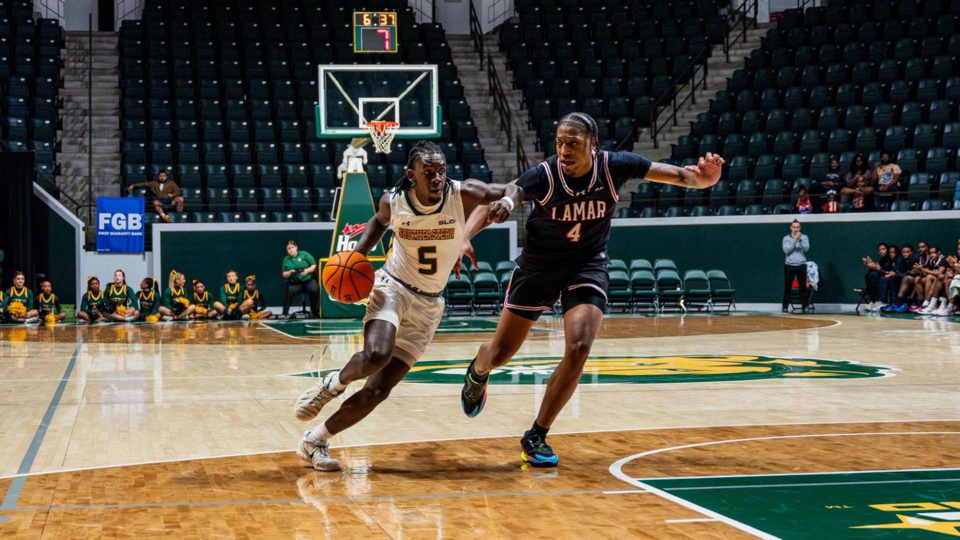 Kyle Edison driving to the rim vs Lamar defender at home