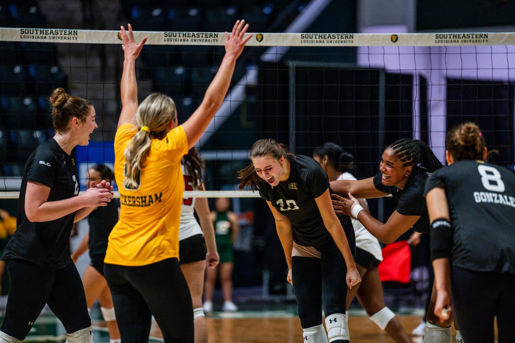 Gracie Brown and the Lions get hyped up after a point in the University Center
