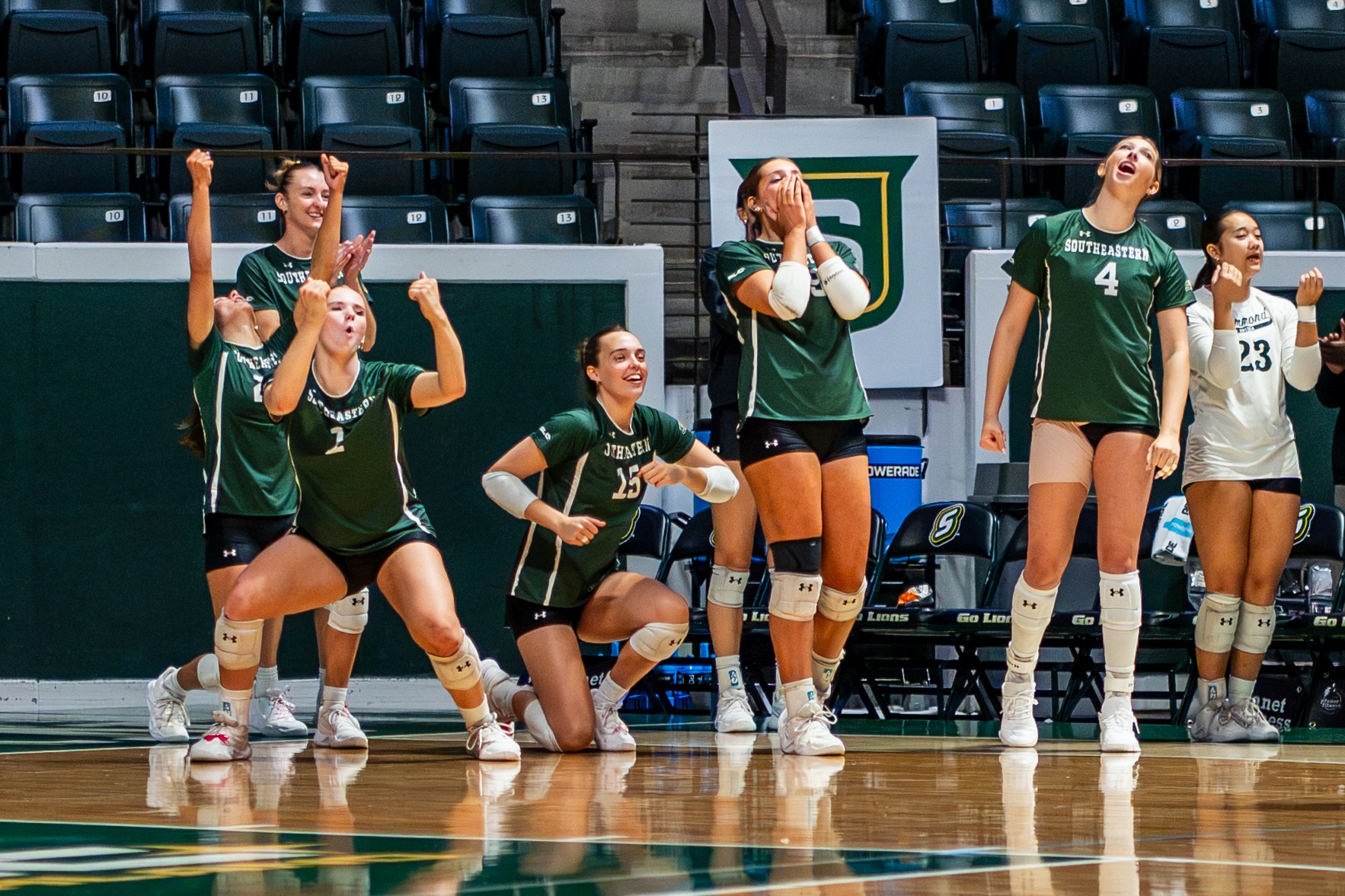 The SLU bench celebrates after a point in the University Center