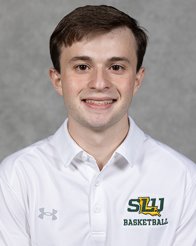 Southeastern men's basketball manager poses for a headshot wearing a white Southeastern basketball polo