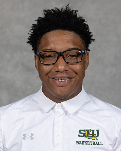 Southeastern men's basketball manager poses for a headshot wearing a white Southeastern basketball polo