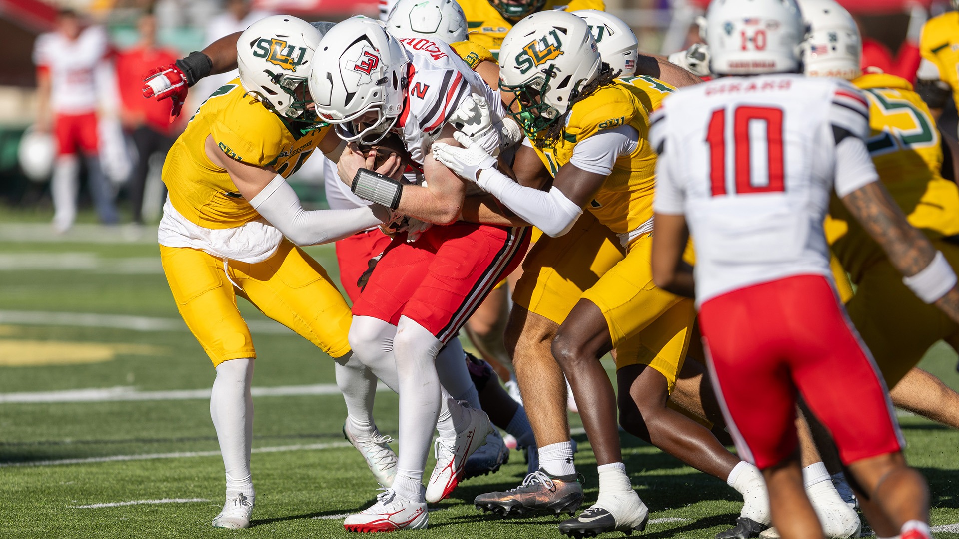 Carter Byrd and CJ Fraser lead a host of Lions tackling Lamar's Aidan McCown Oct. 17, 2026