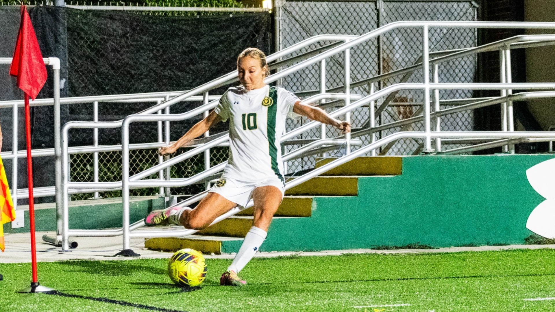 Kaitlyn Tung (white jersey) kick the ball for a corner kick vs Northwestern State
