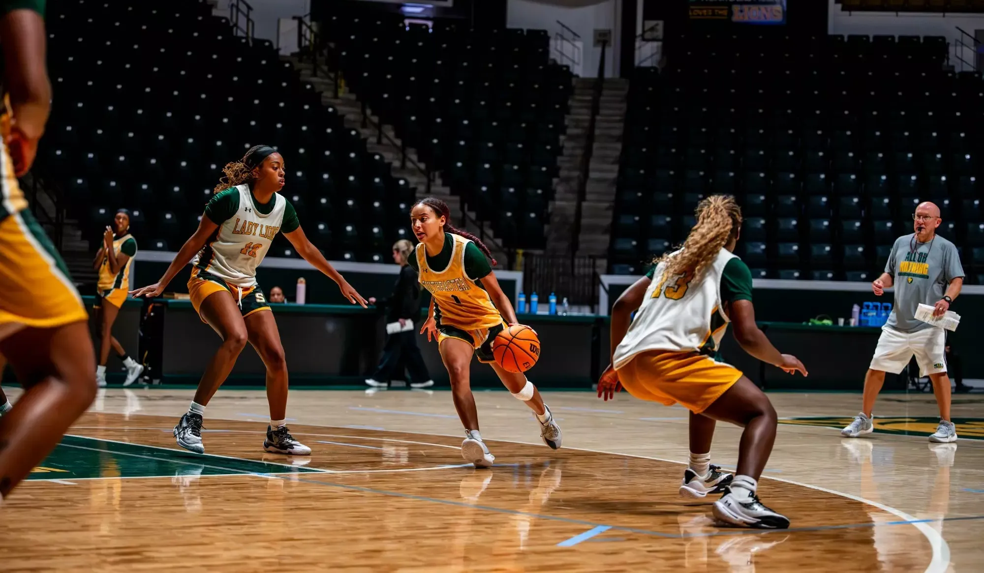 Natalie Huff dribbles past Ne'talya Hurst at practice in the University Center