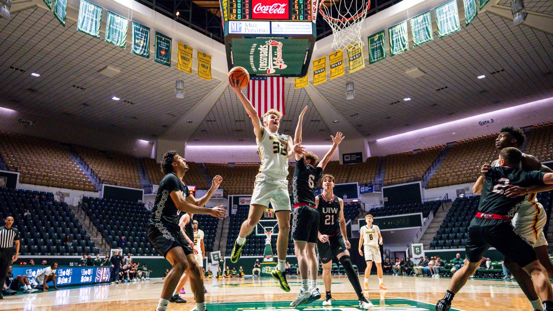 Garrett Shoemaker finishing around the rim vs UIW defender in the University Center