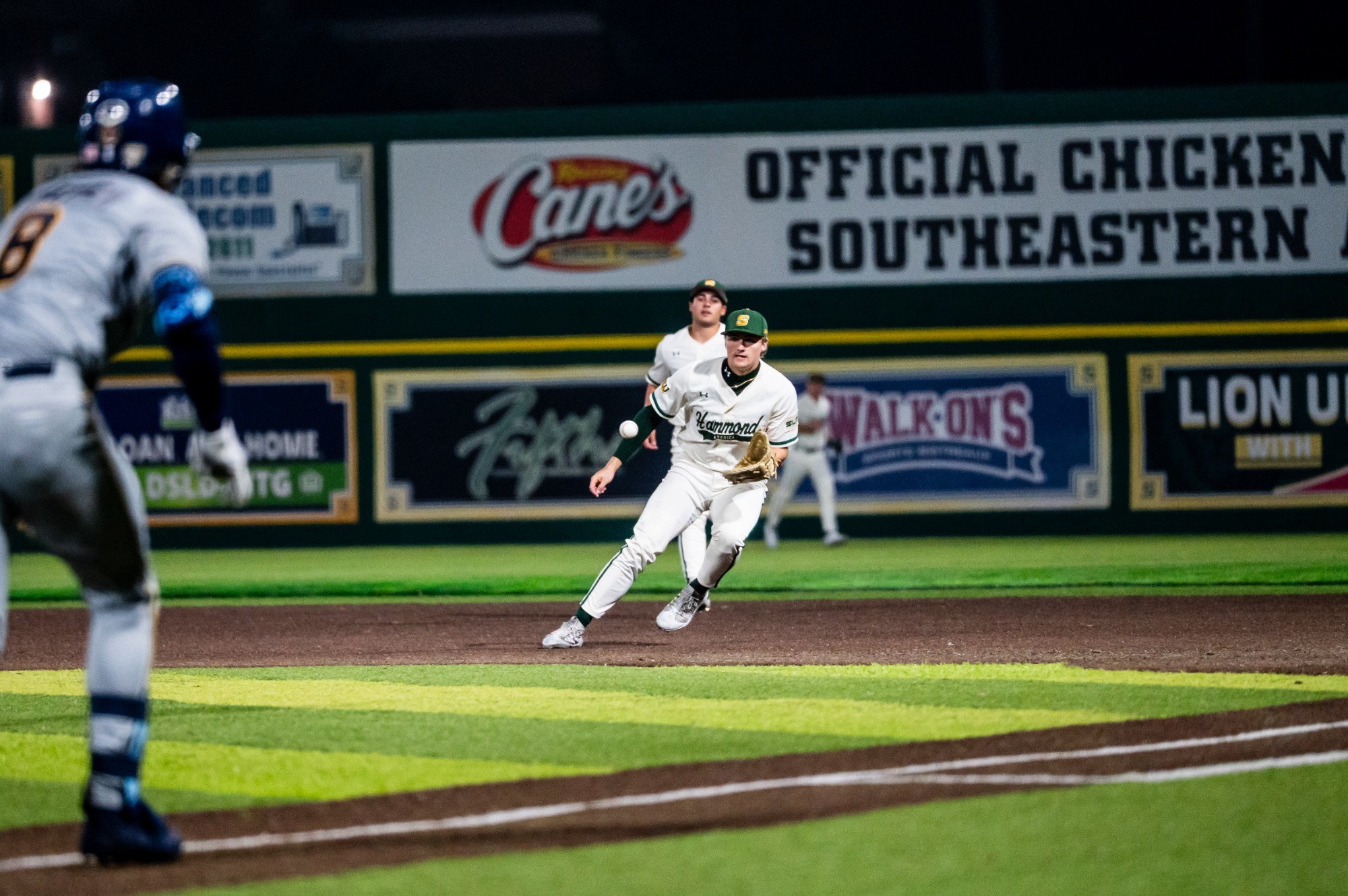 SLU first baseman Brody Capps fields a ground ball and breaks to the bag ahead of the Kent State runner bearing down the line.