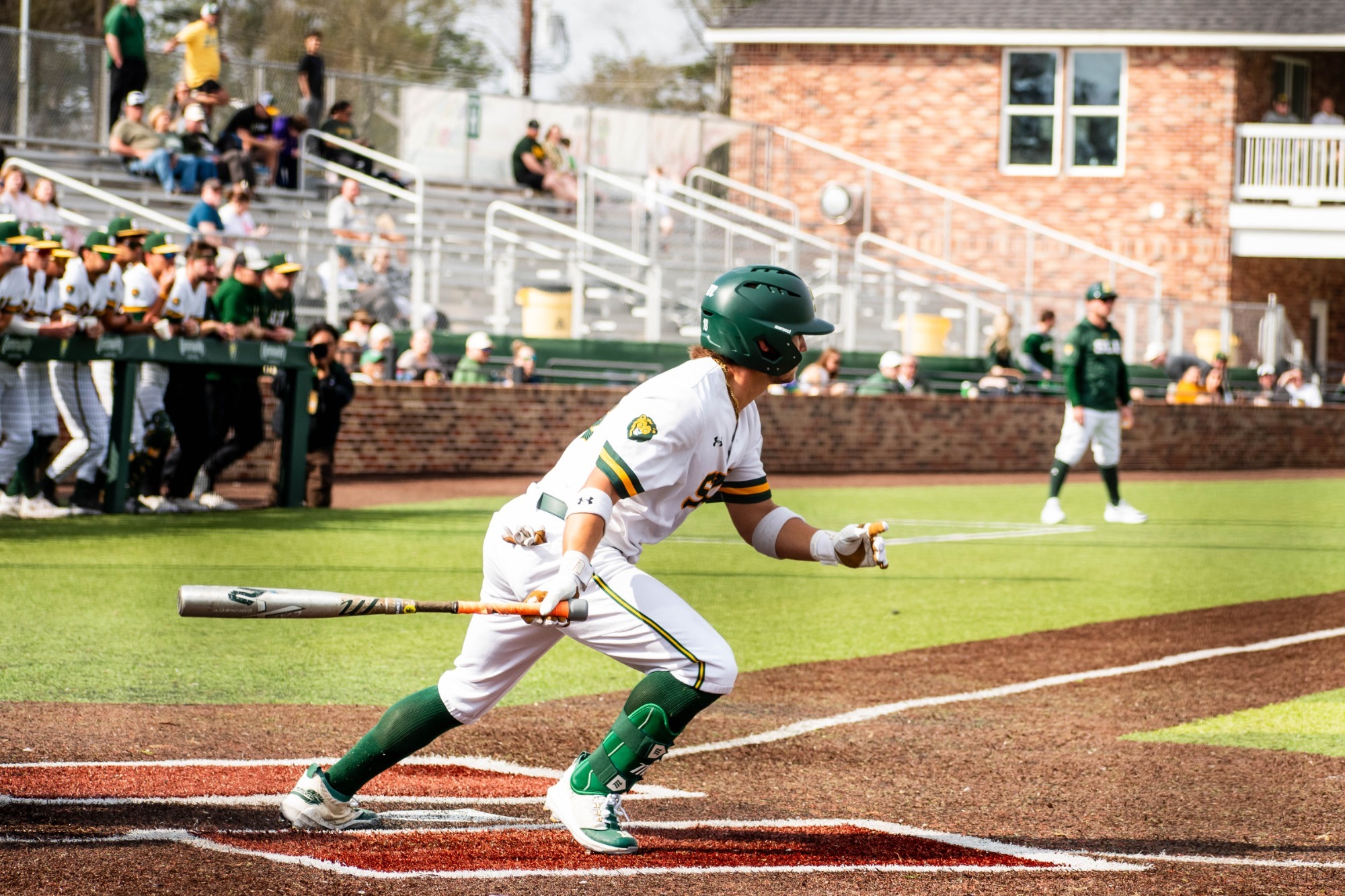 Dane Watts drops his bat as he sprints out of the box toward first base.